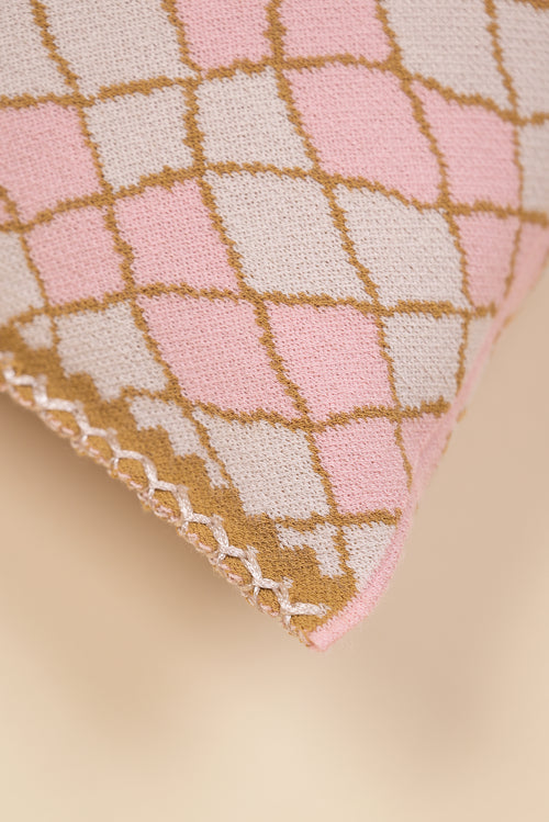 corner of pink bow-shaped knit pillowcase with romb pattern in viscose