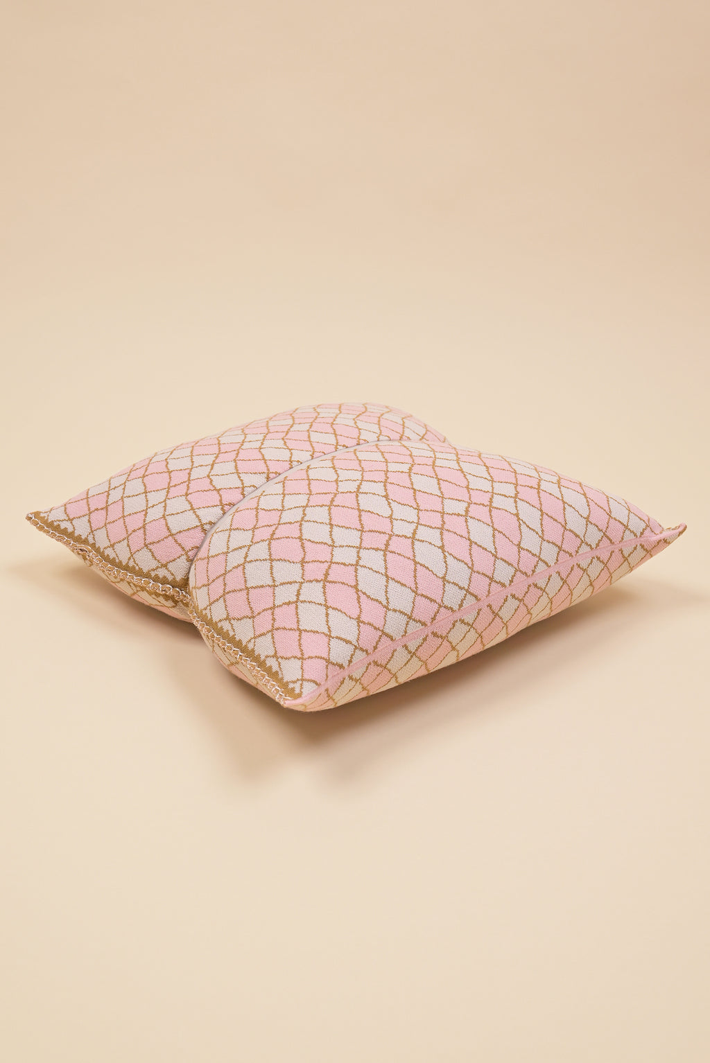 laid flat pink bow-shaped knit pillowcase with romb pattern in viscose