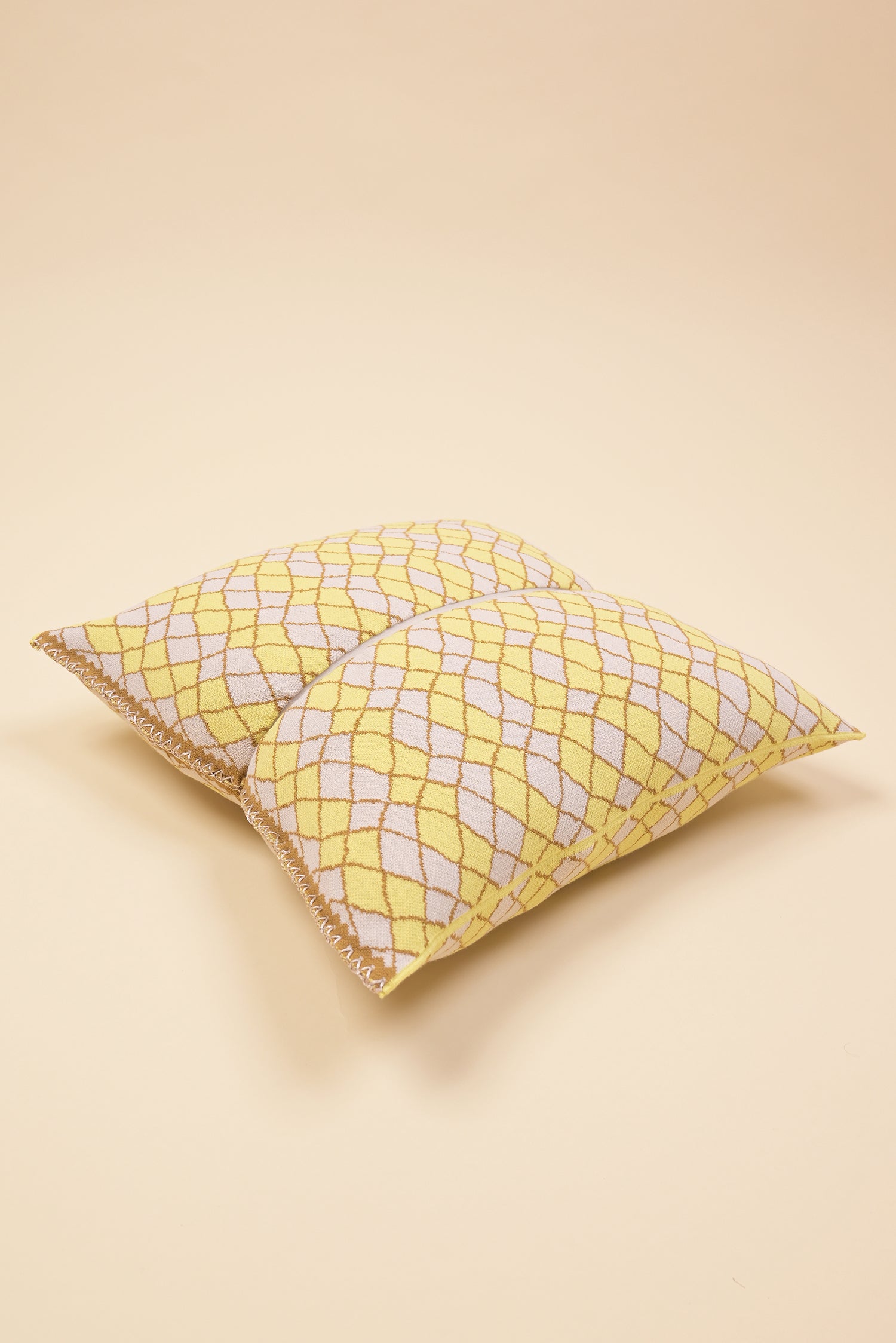 laid flat yellow bow-shaped knit pillowcase with romb pattern in viscose