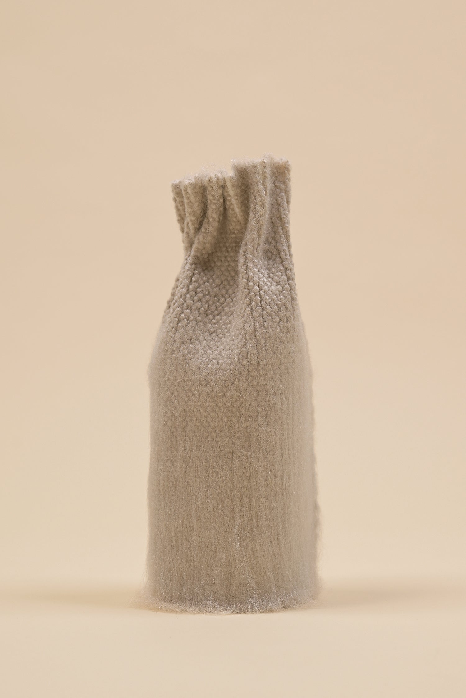 front view of beige knit textile vase in brushed silk and organic cotton with beige background