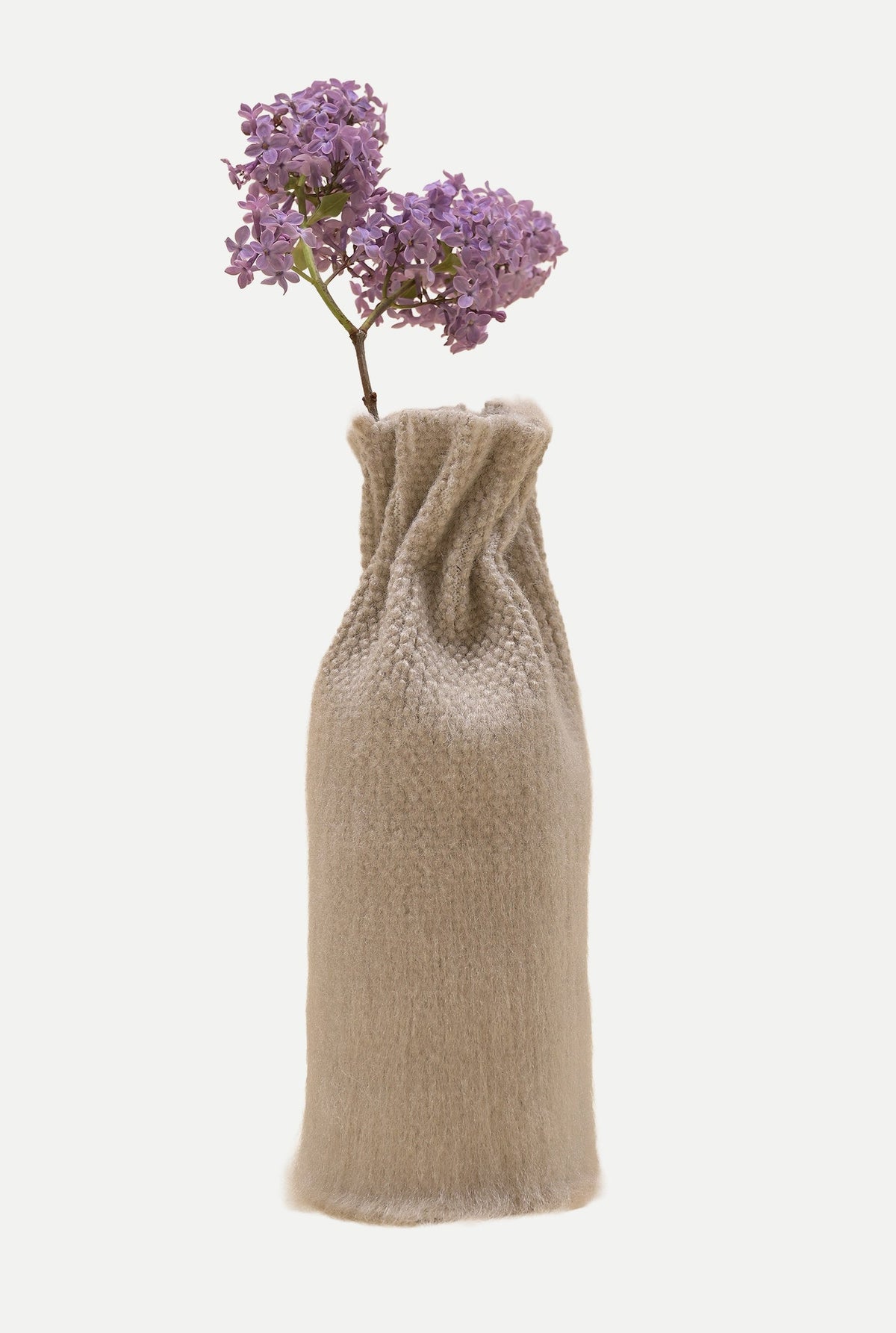 [beige][open] beige knit textile vase with a spray of purple lilac