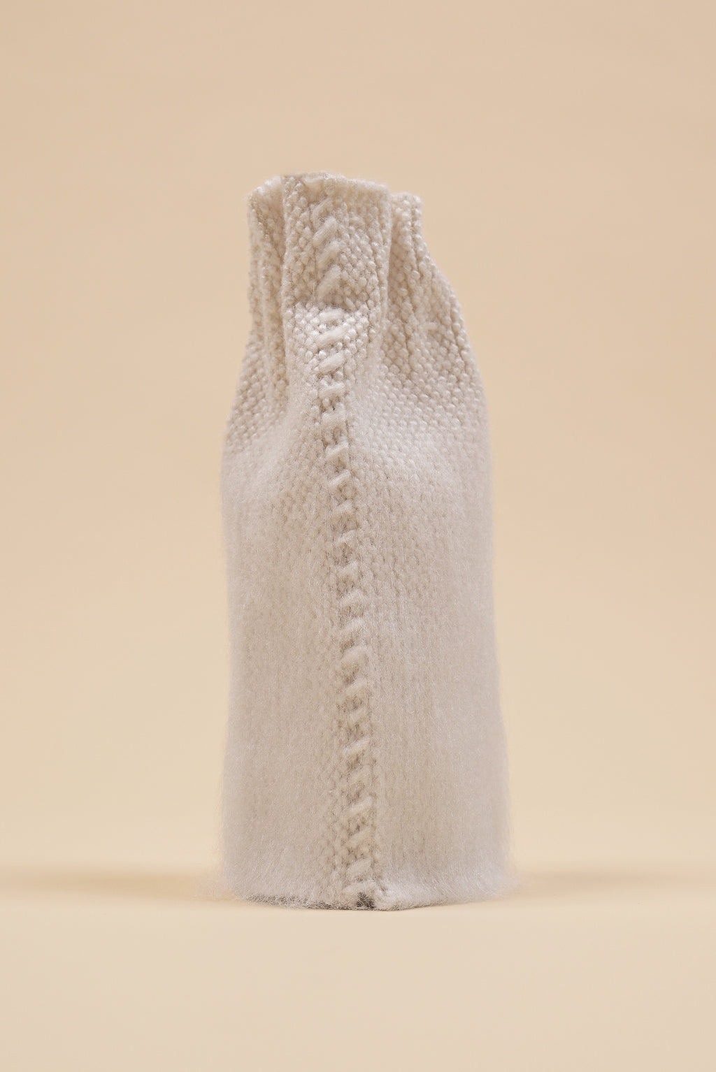 back view of off-white knit textile vase in brushed silk and organic cotton