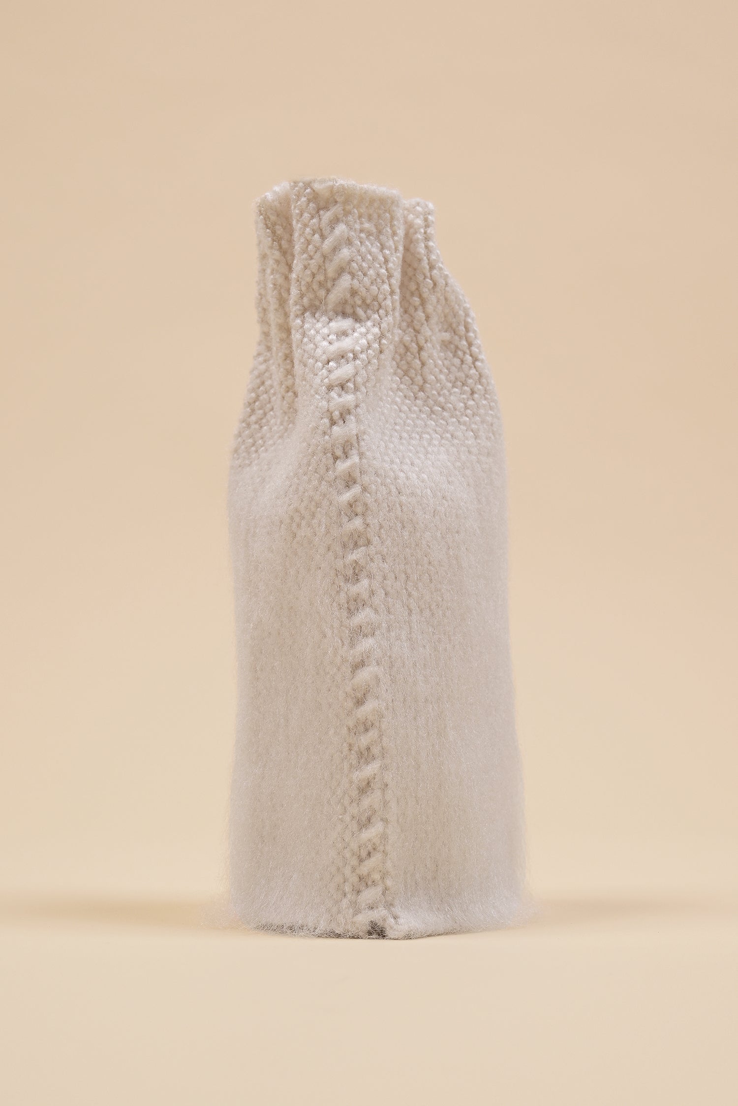back view of off-white knit textile vase in brushed silk and organic cotton