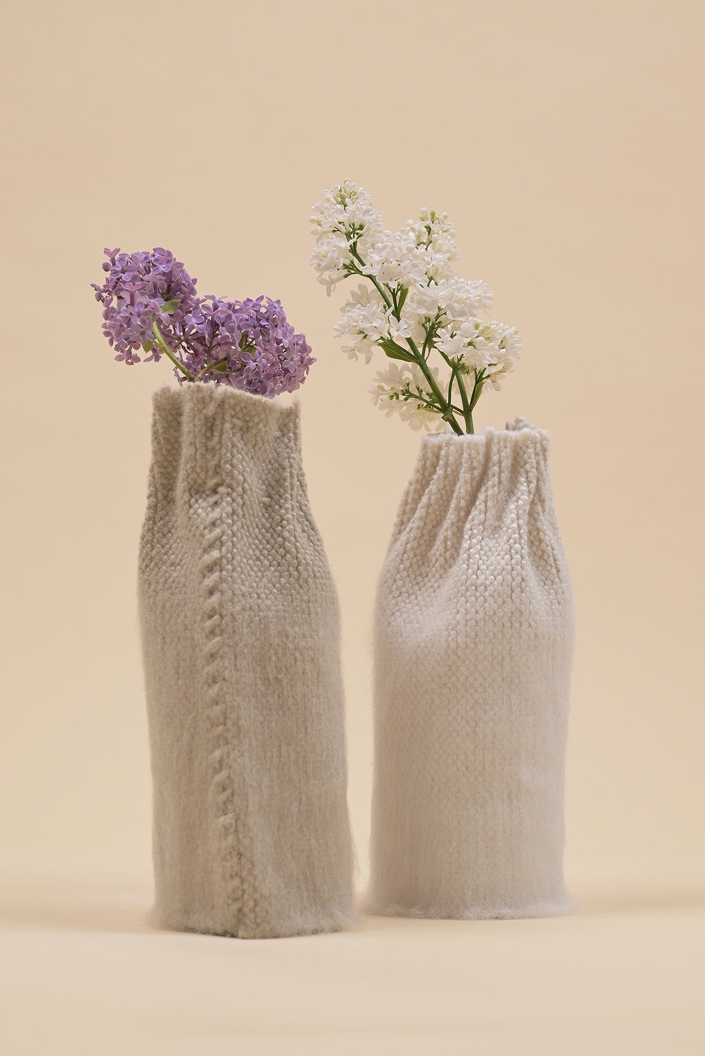 off-white knit textile vase in brushed silk and organic cotton displayed with beige vase
