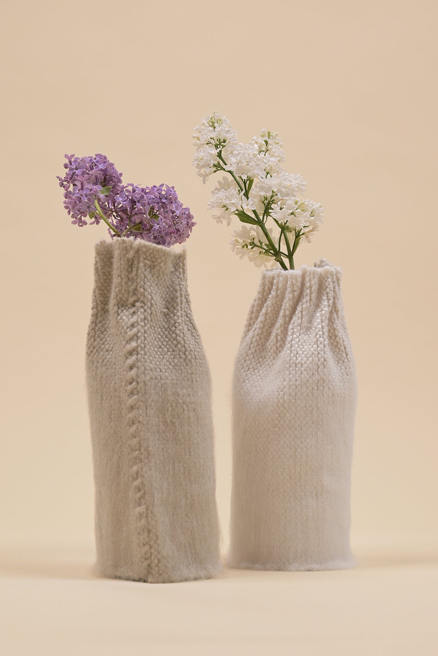 off-white knit textile vase in brushed silk and organic cotton displayed with beige vase