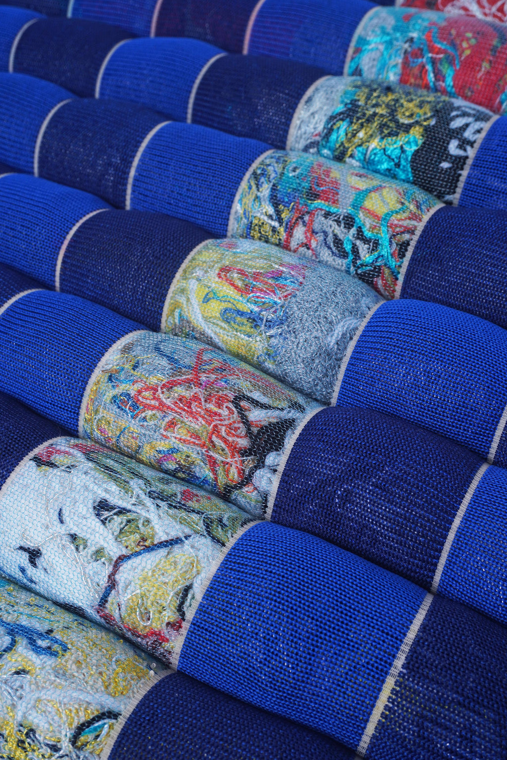 closeup of blue/navy knit checkered seat cushion with upcycled materials