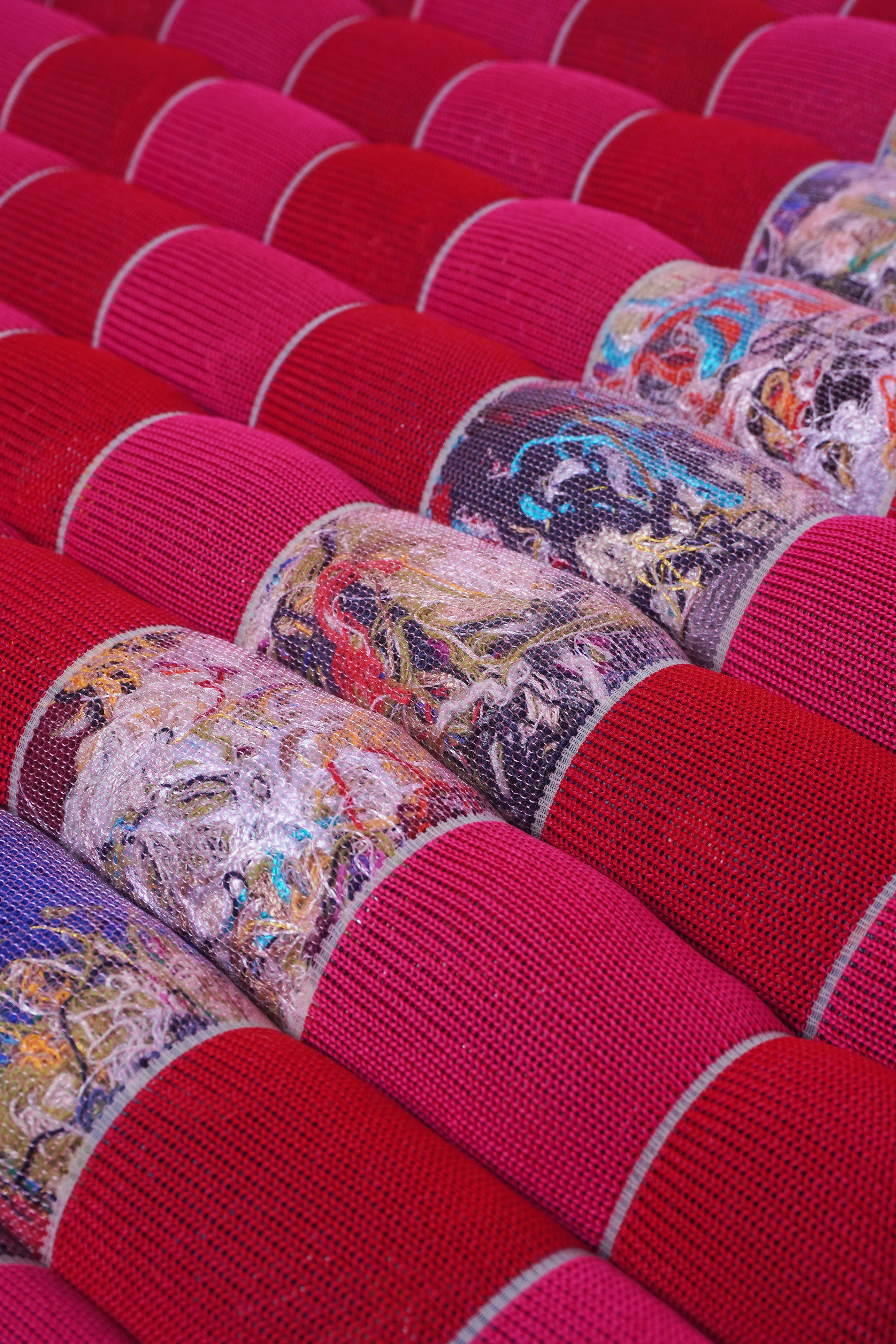 detail of red/pink knit checkered seat cushion with upcycled materials