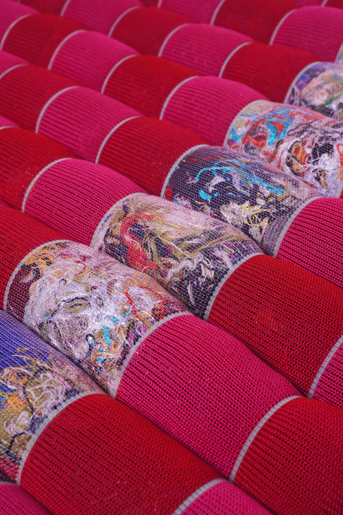 detail of red/pink knit checkered seat cushion with upcycled materials