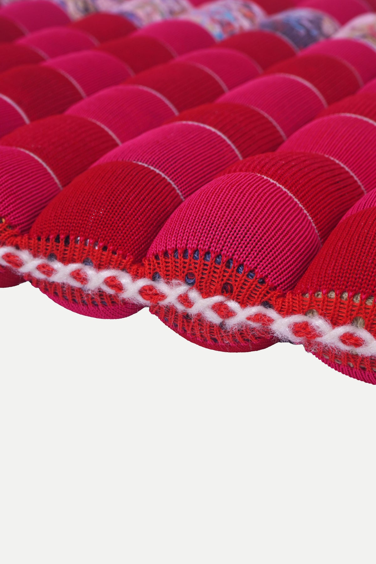 [red/pink] full view of the red and pink checkered knit seat cushion with tie straps