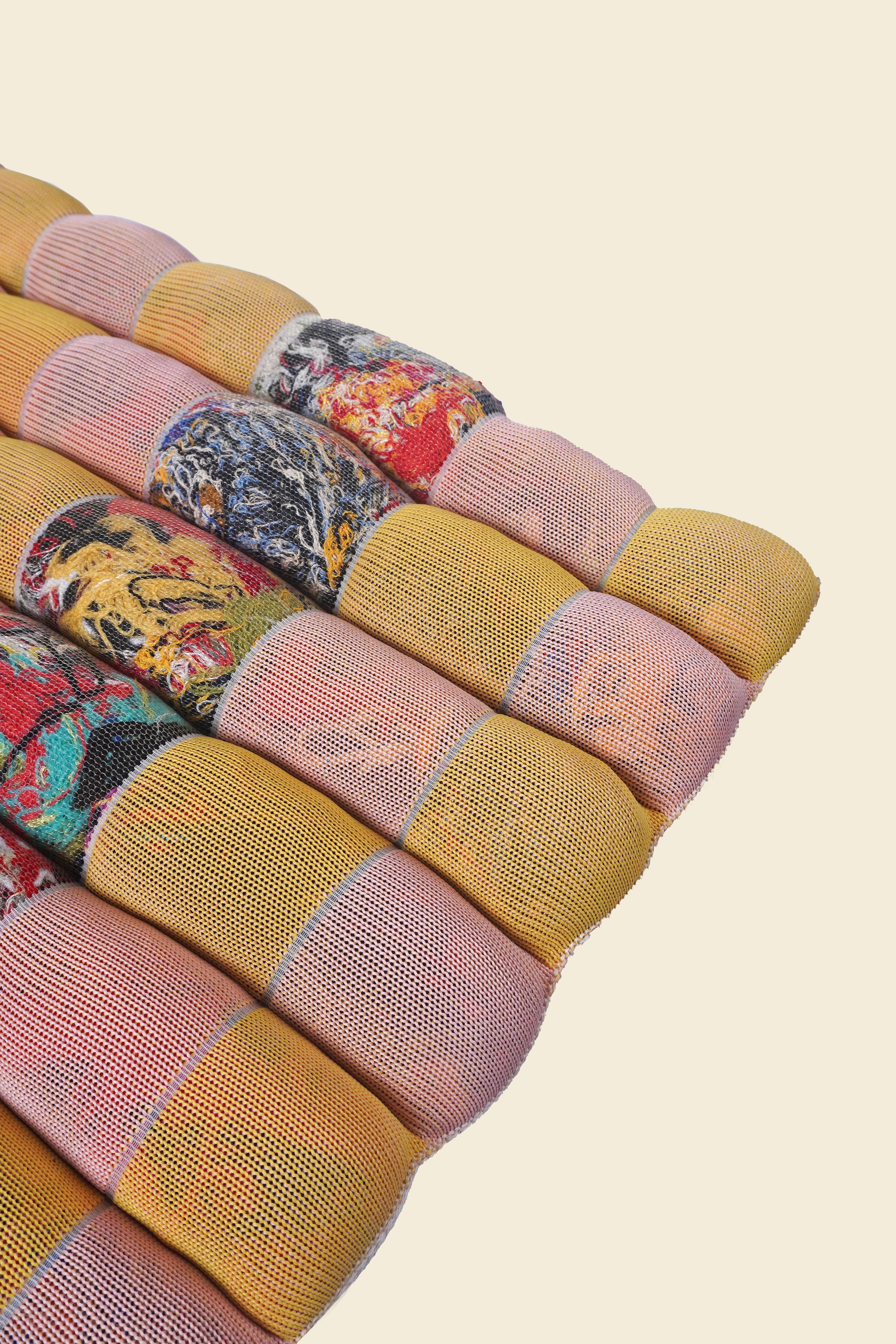 corner of yellow/pink knit checkered seat cushion with upcycled materials