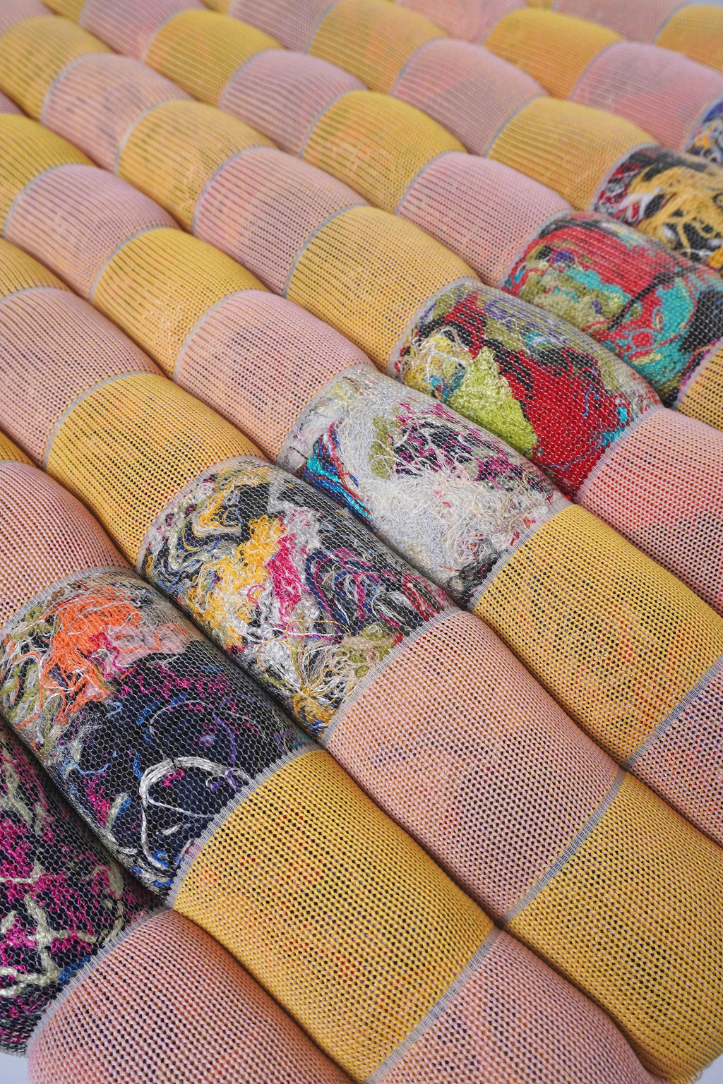 detail of yellow/pink knit checkered seat cushion with upcycled materials