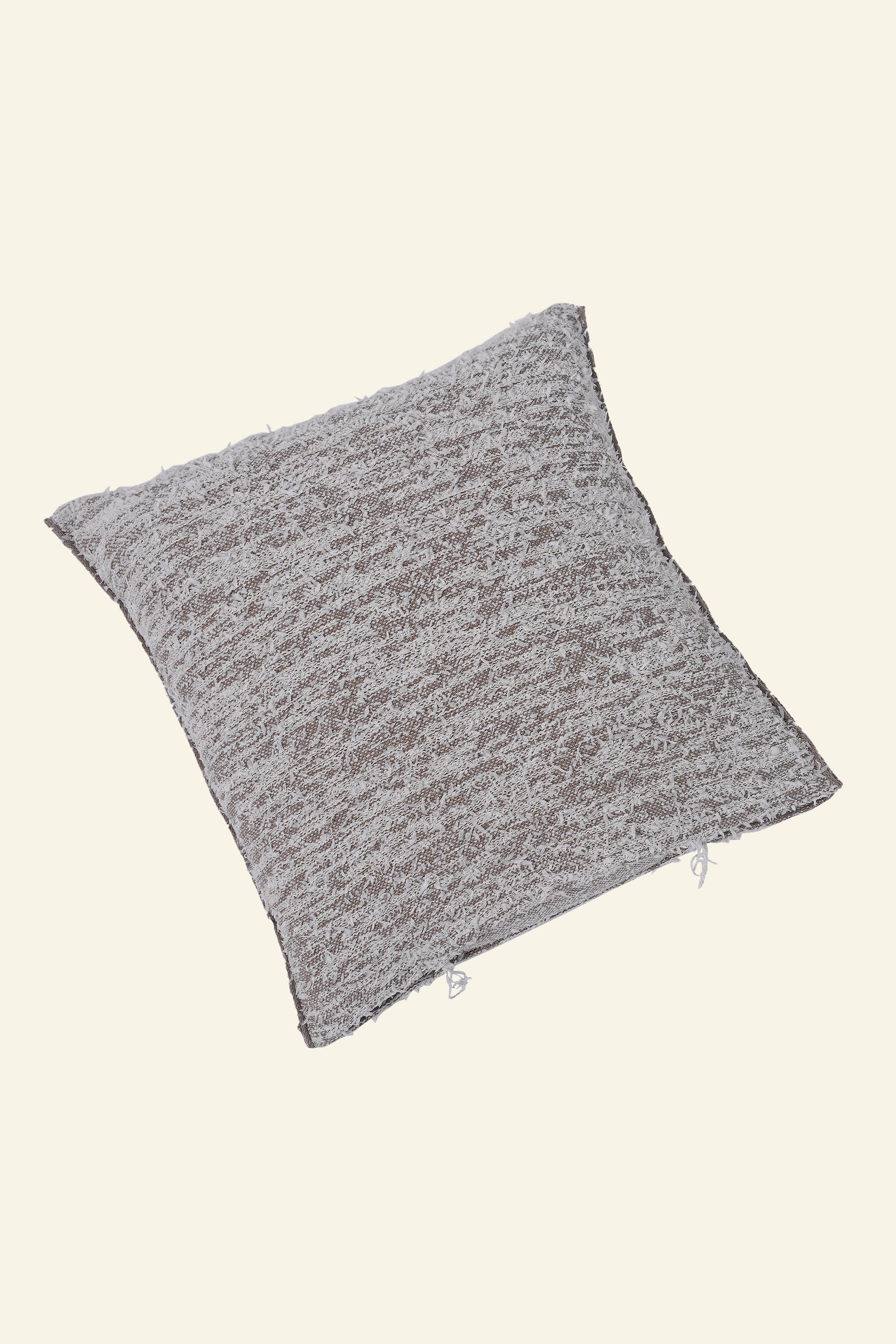 flat laid beige fuzzy knit pillowcase in organic cotton and recycled polyamide
