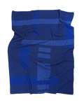 front side of blue geometric column knit blanket in merino wool and organic cotton