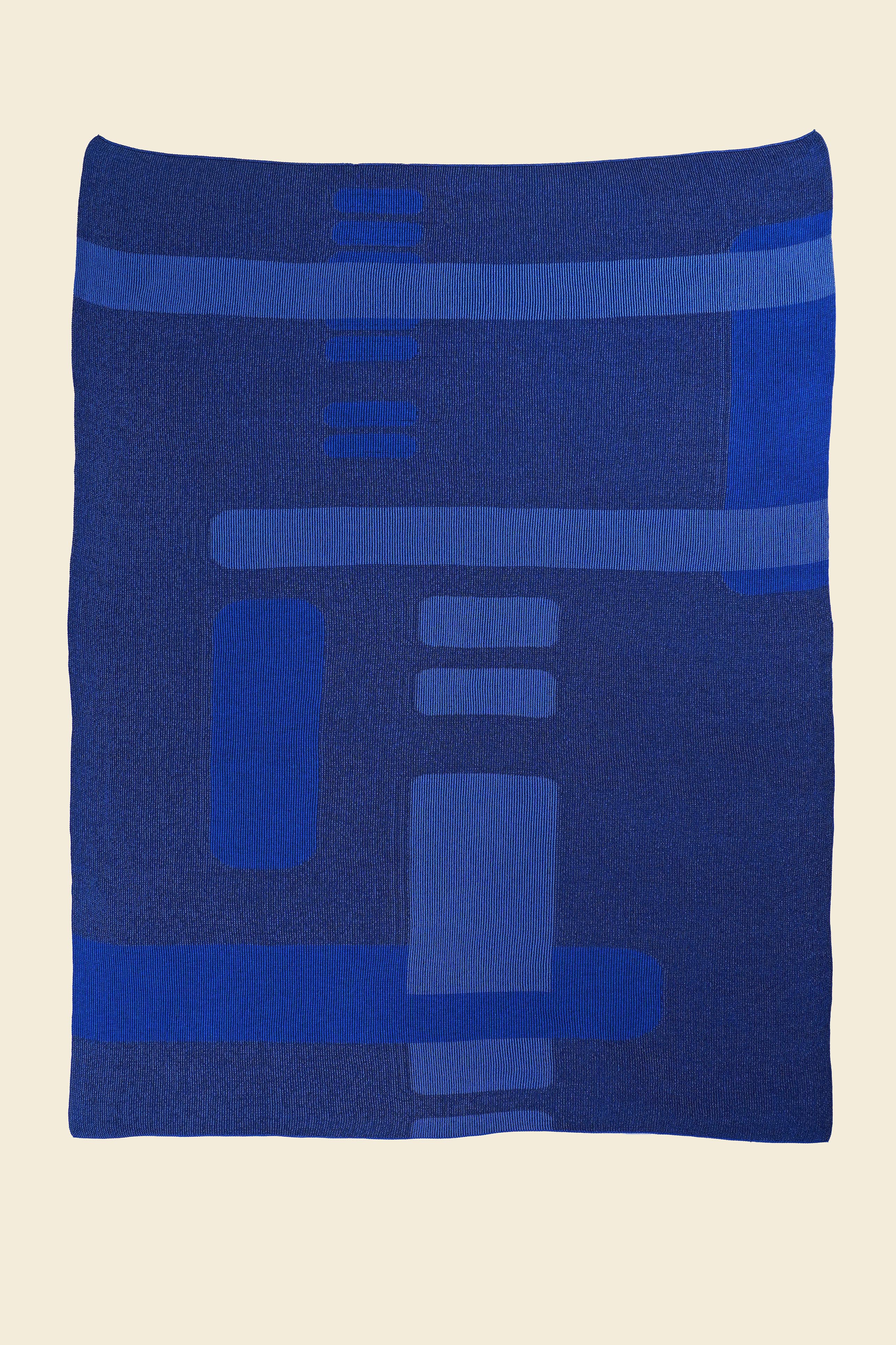 laid flat blue geometric column knit blanket in merino wool and organic cotton