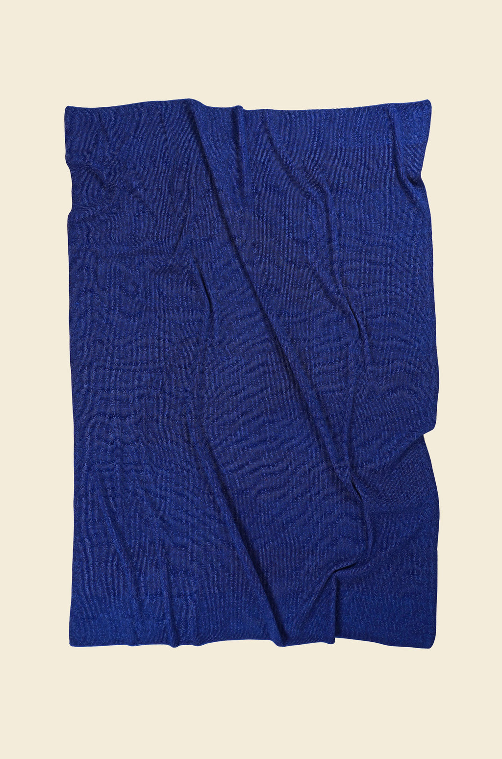 back side of blue/purple geometric ikat knit blanket in merino wool and organic cotton