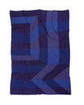front side of blue/purple geometric ikat knit blanket in merino wool and organic cotton