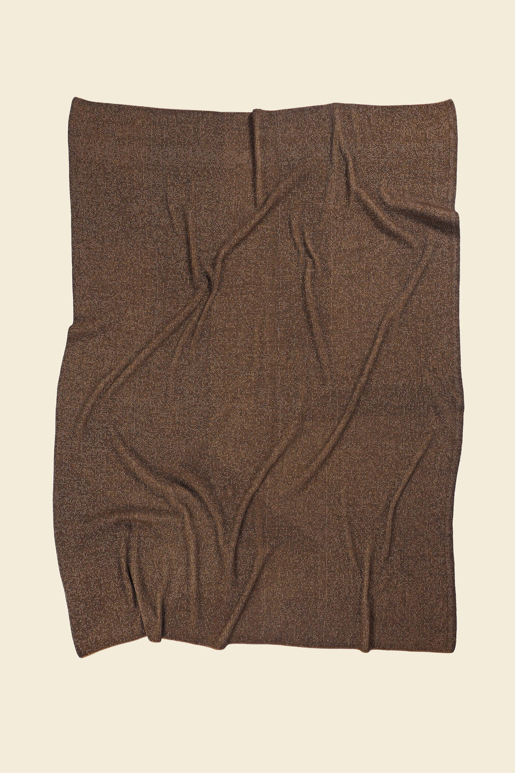 back side of brown/gold geometric ikat knit blanket in merino wool and organic cotton