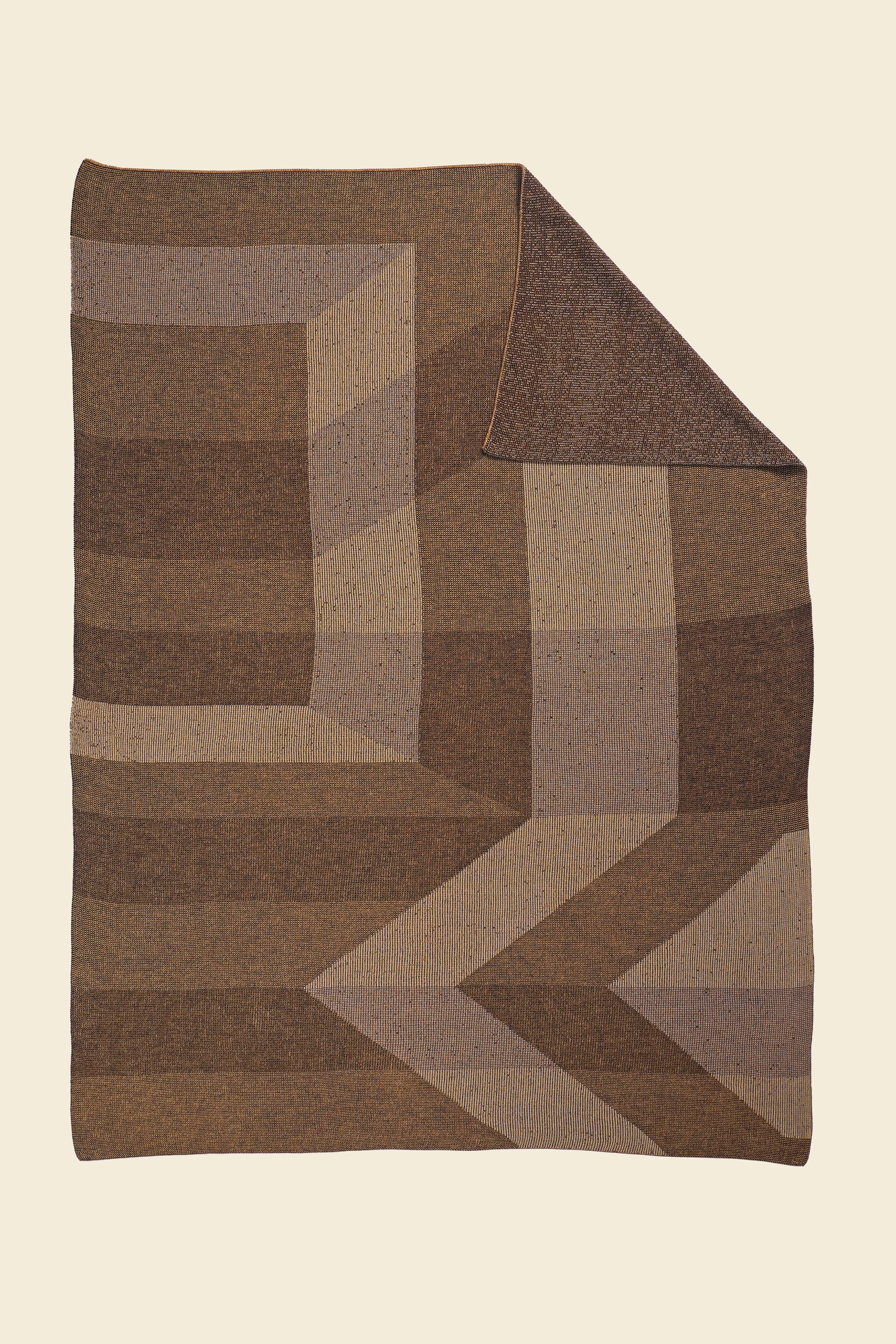 brown/gold geometric ikat knit blanket with flipped corner in merino wool and organic cotton