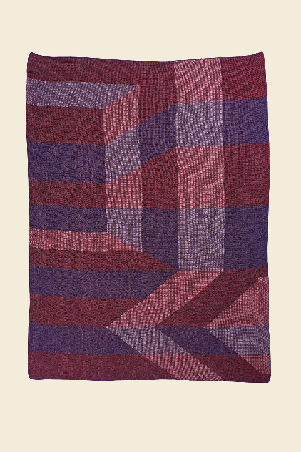 laid flat red/purple geometric ikat knit blanket in merino wool and organic cotton
