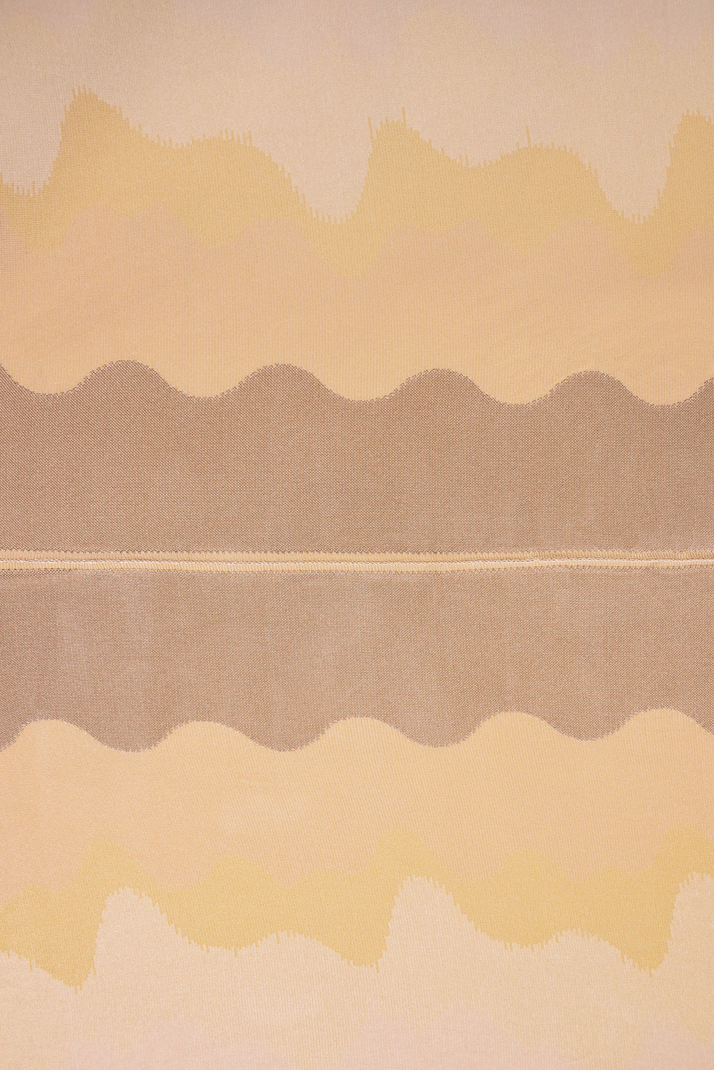 top view detail of organic cotton knit tablecloth with hand-stitched seam in yellow monochrome tones