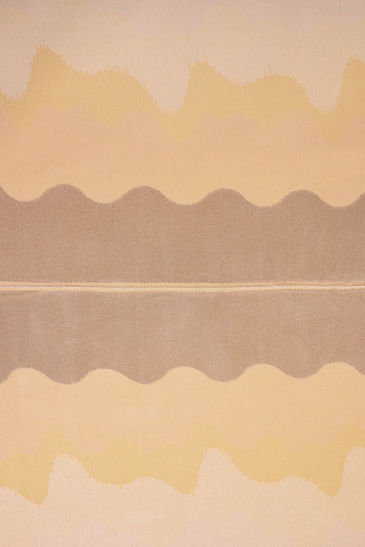 top view detail of organic cotton knit tablecloth with hand-stitched seam in yellow monochrome tones