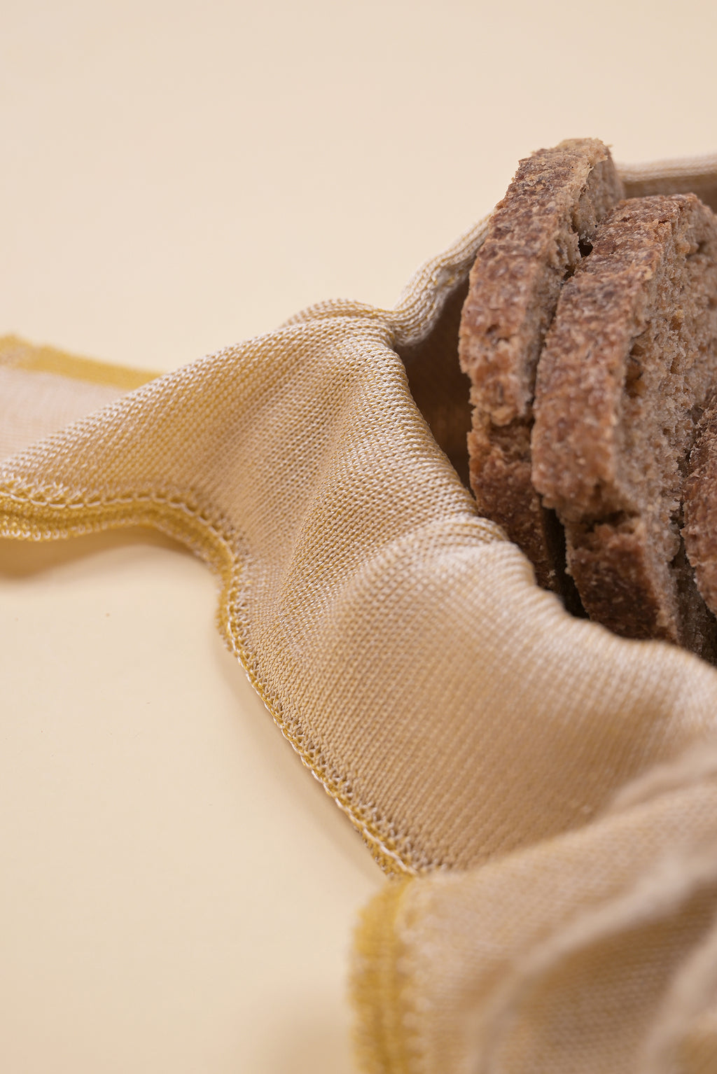 close-up of yellow and beige organic cotton, hemp and viscose knit bread basket