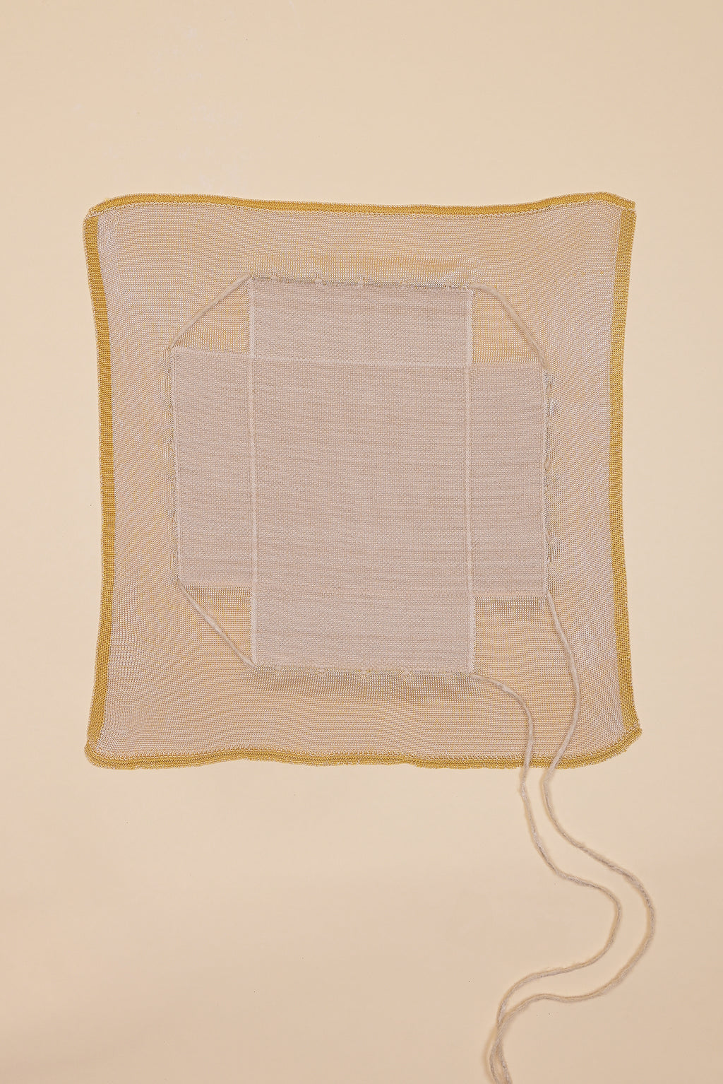 top view of yellow and beige organic cotton, hemp and viscose knit bread basket unfolded