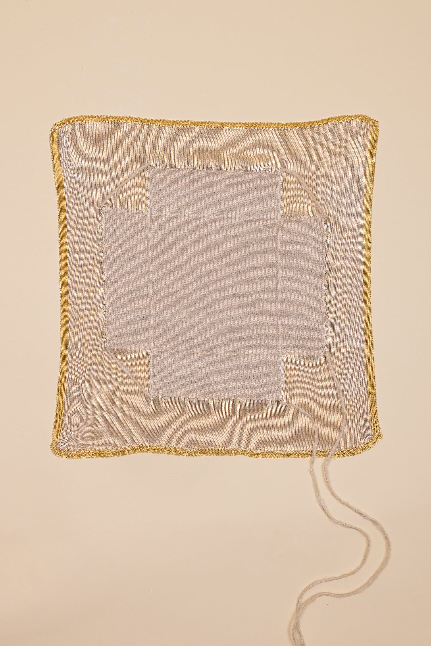 top view of yellow and beige organic cotton, hemp and viscose knit bread basket unfolded