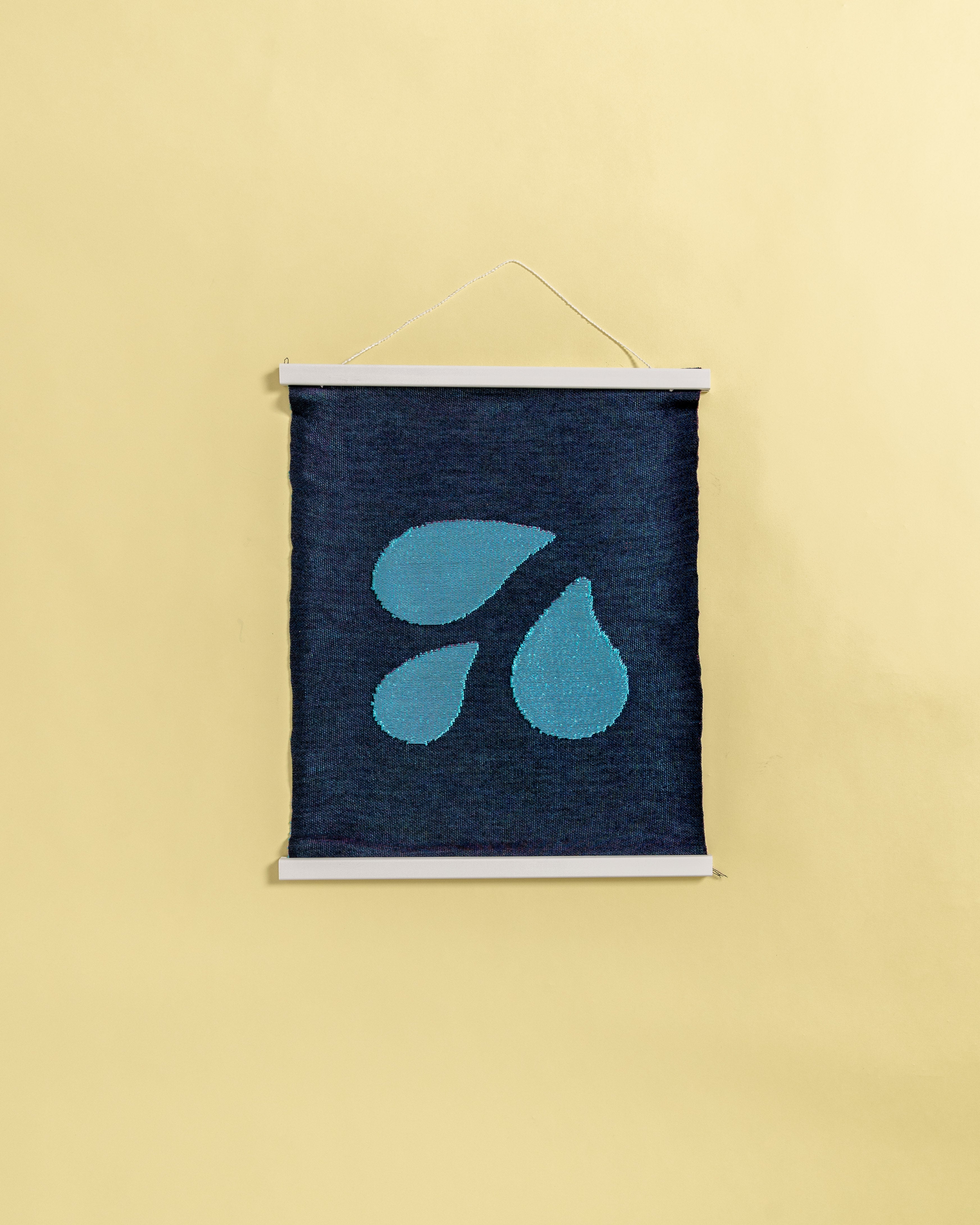 back view of blue knit wall hanging with wooden magnetic frame