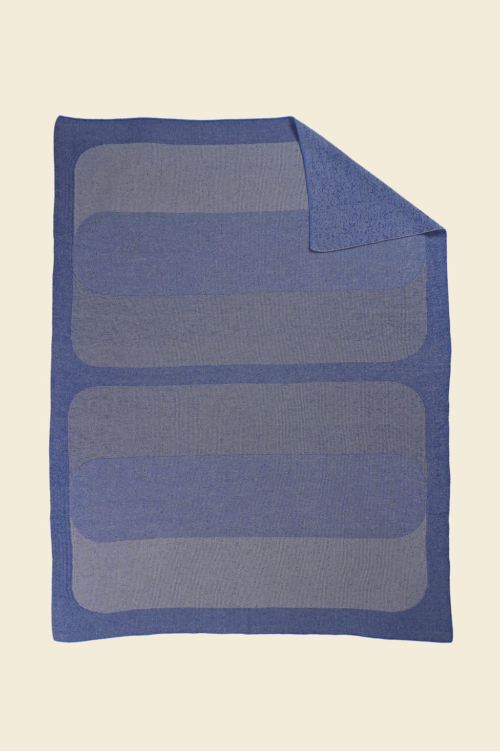 grey/blue knit blanket with flipped corner and with rectangles in merino wool and organic cotton
