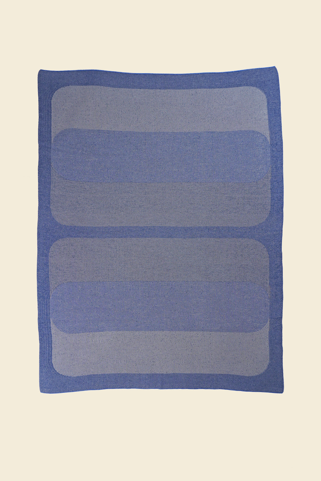 laid flat grey/blue knit blanket with rectangles in merino wool and organic cotton