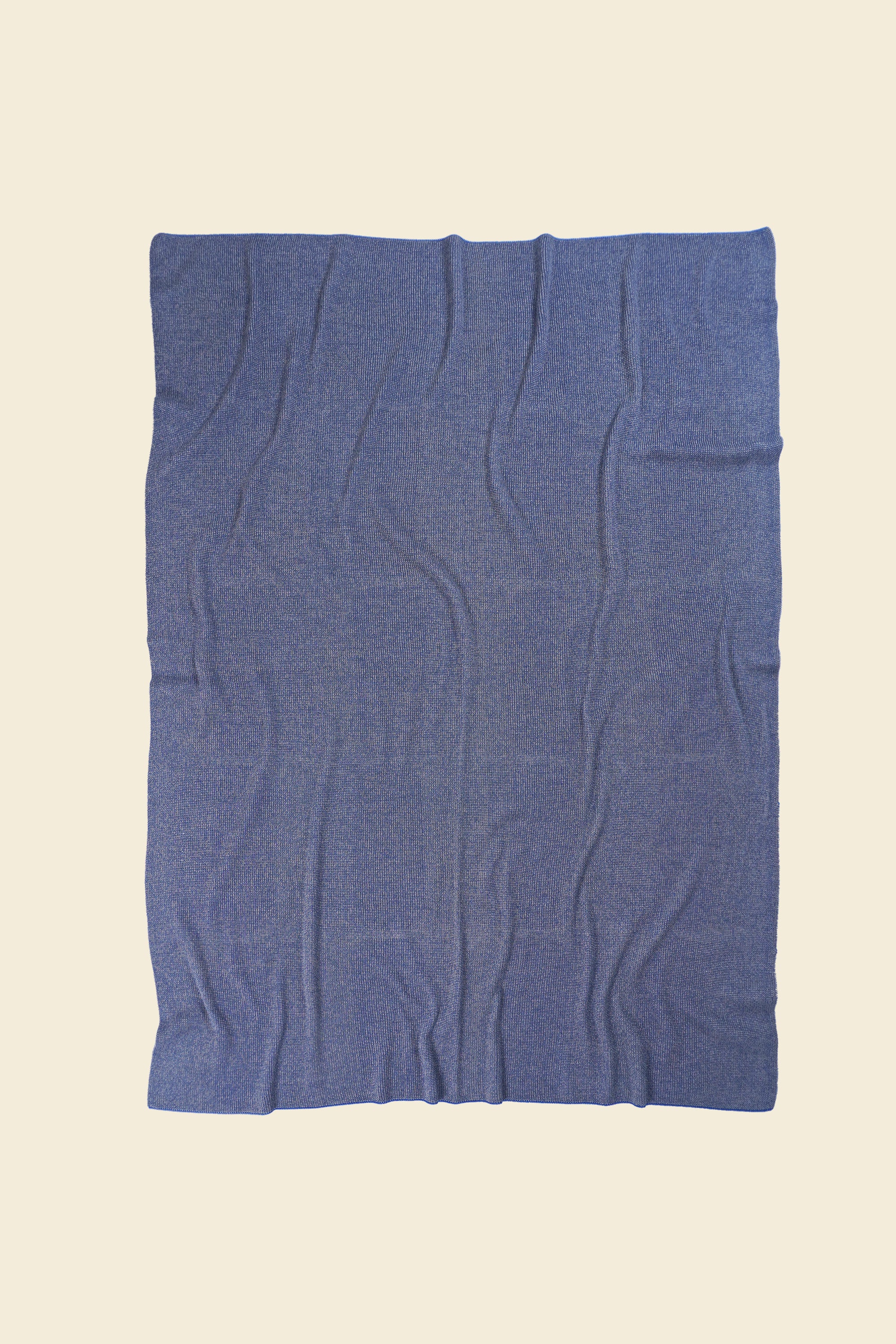 back side of grey/blue knit blanket in merino wool and organic cotton