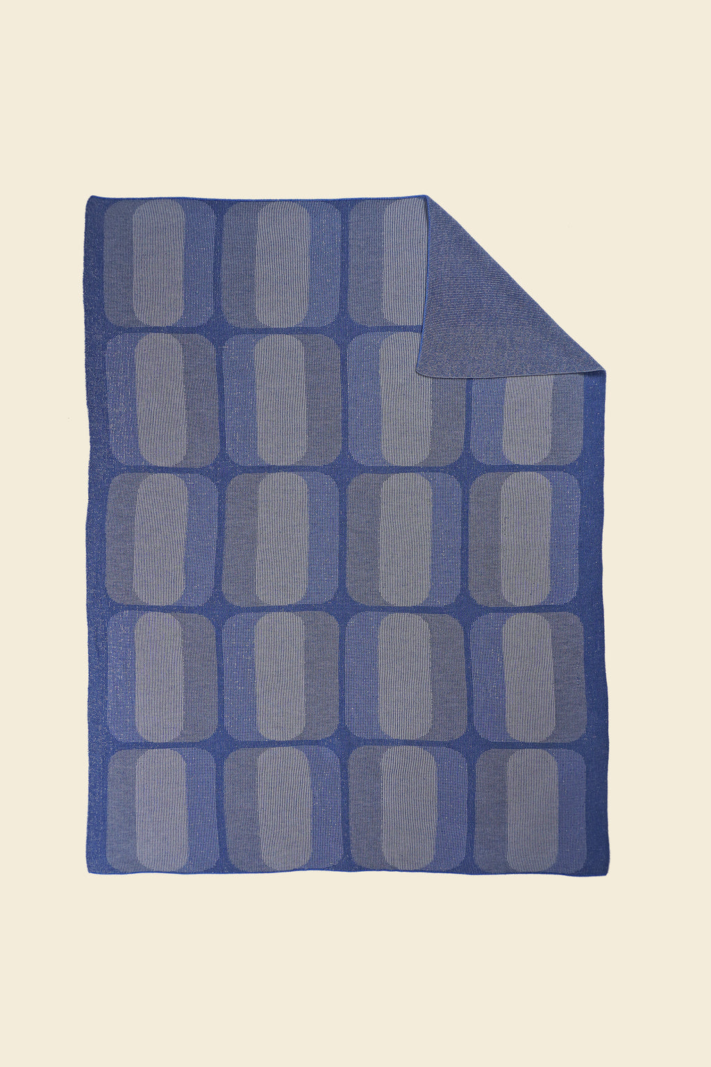 grey/blue geometric knit blanket with flipped corner in merino wool and organic cotton