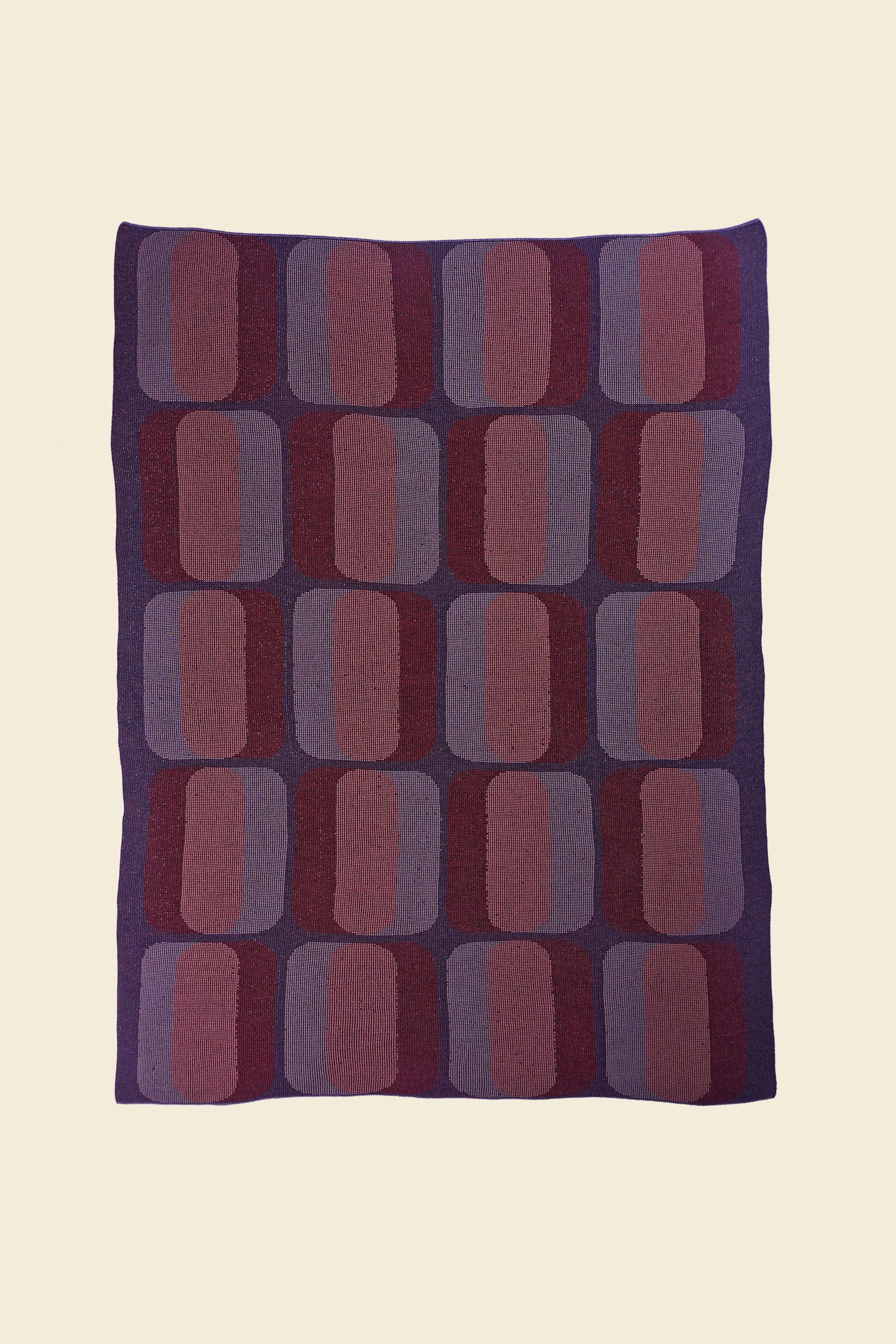 laid flat red/purple geometric knit blanket in merino wool and organic cotton