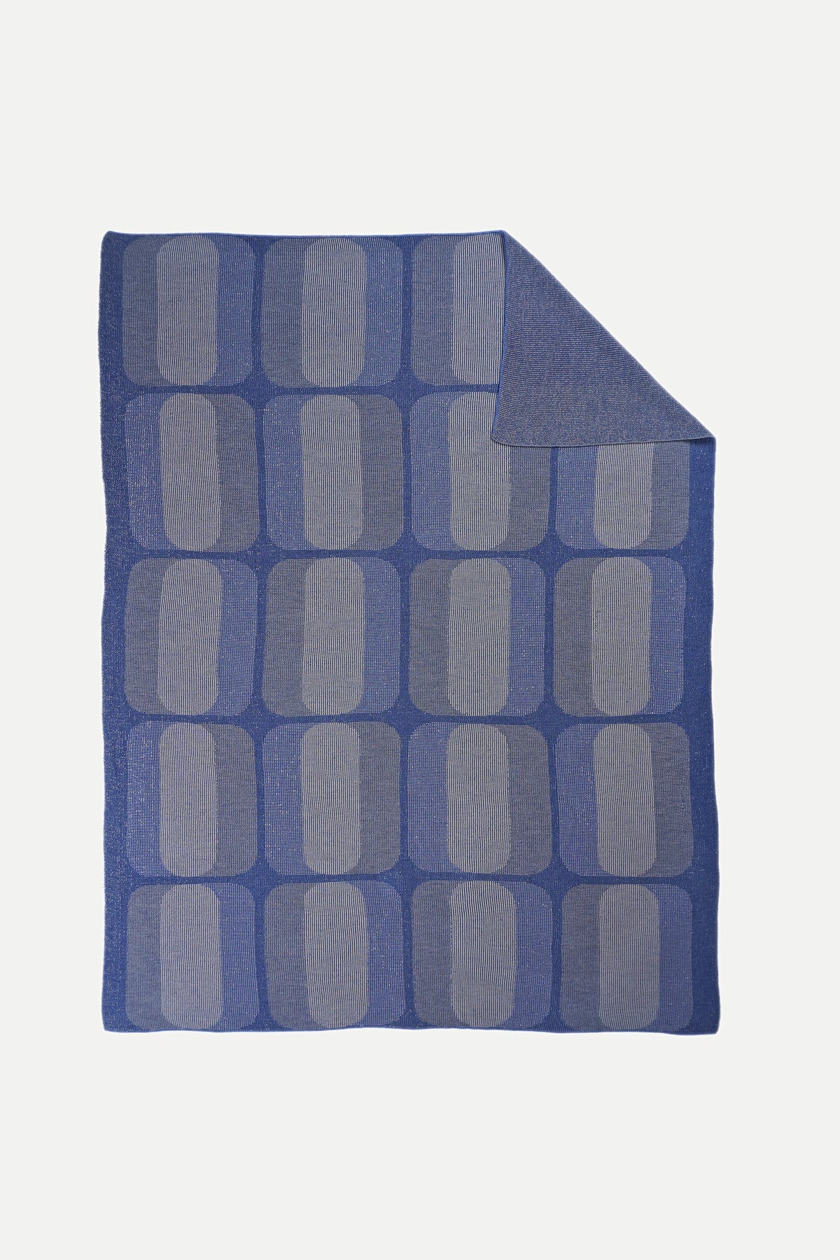 mini-graphic knit blanket in grey and blue, folded corner showing front and reverse side, wool and organic cotton [grey/blue]