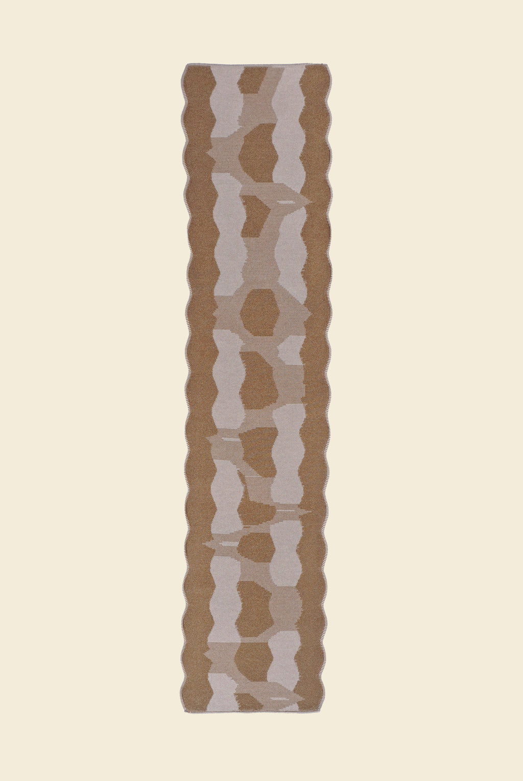 back side top view of beige knit organic cotton and viscose table runner with abstract pattern and wavy edges