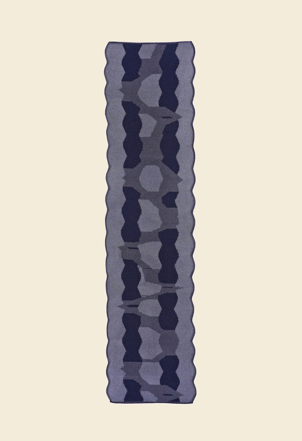 back side of grey knit organic cotton and viscose table runner with abstract pattern and wavy edges