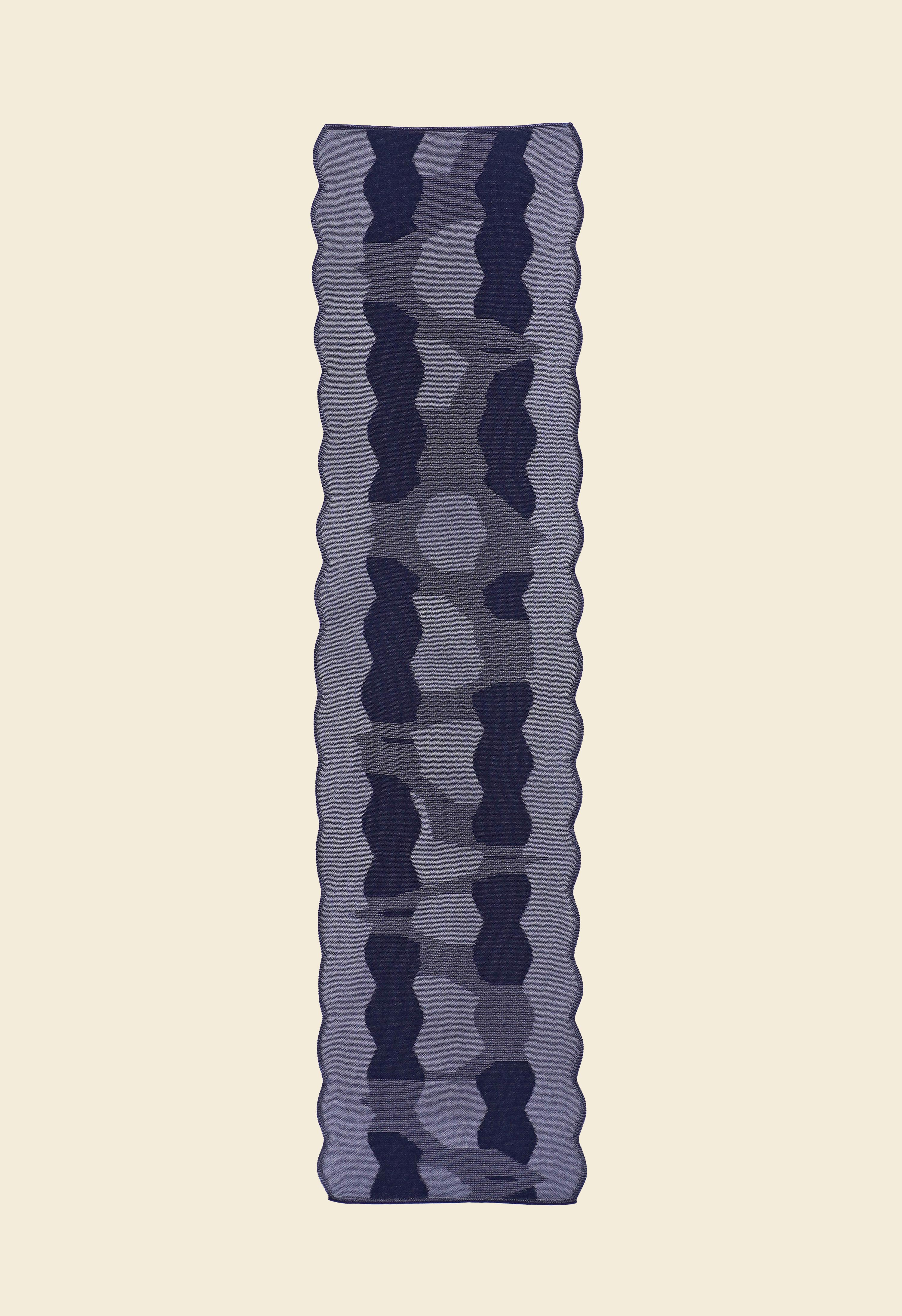 back side of grey knit organic cotton and viscose table runner with abstract pattern and wavy edges