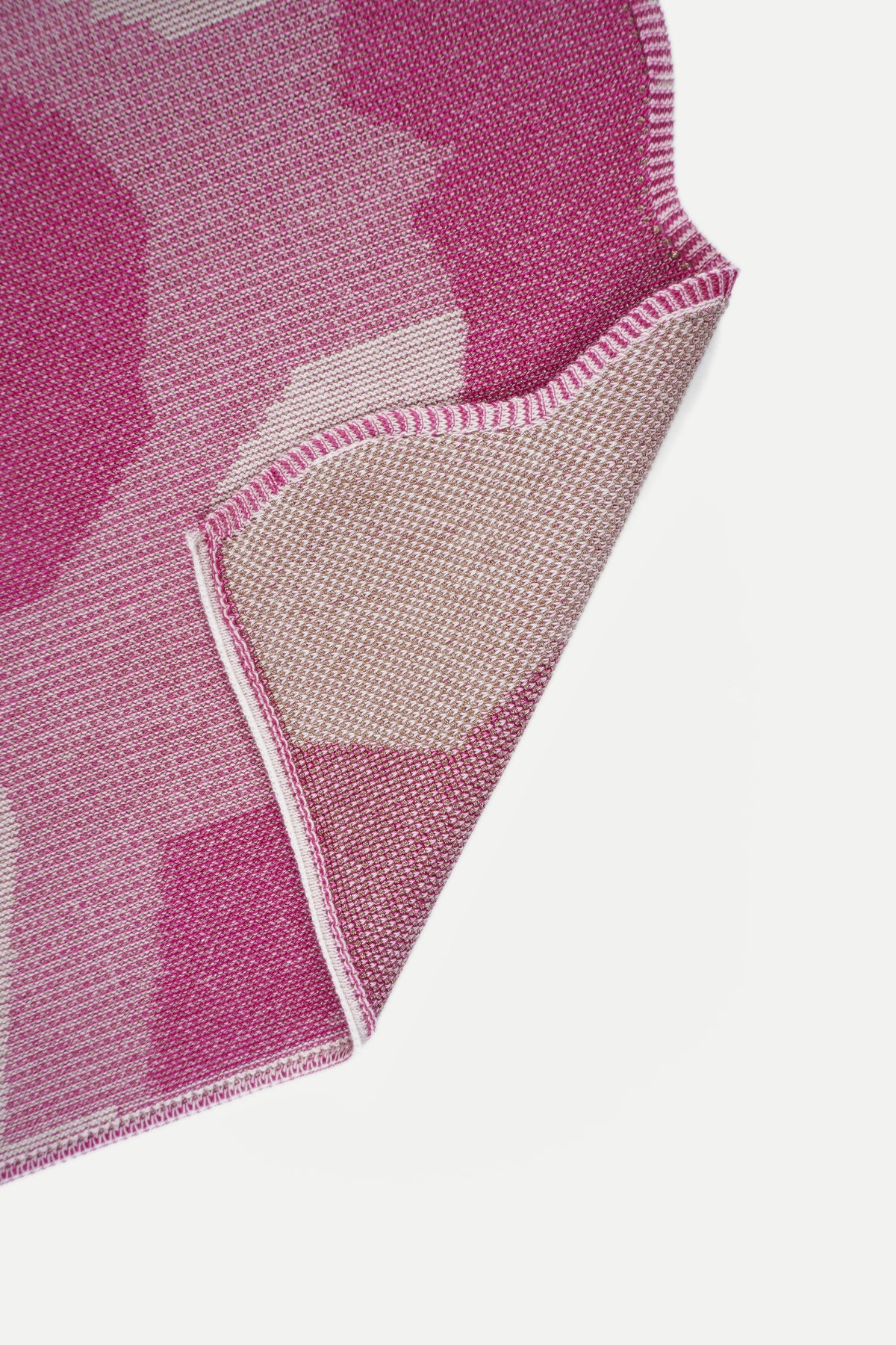 close-up of the woven texture and wavy edge of [pink] organic cotton and viscose table runner