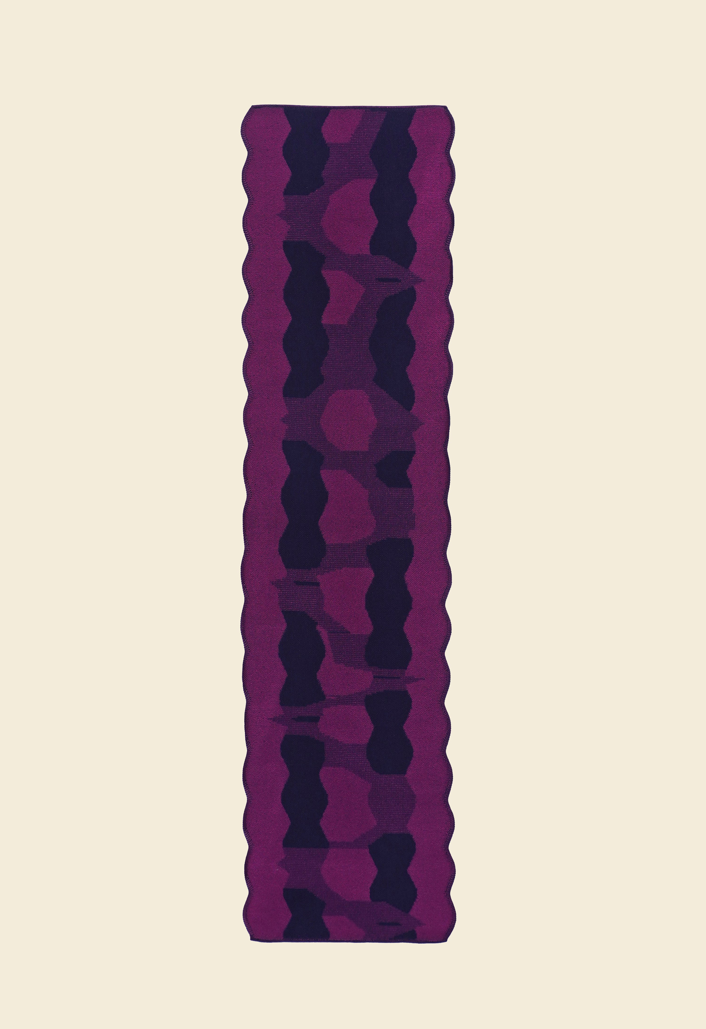 back side top view of purple knit organic cotton and viscose table runner with abstract pattern and wavy edges