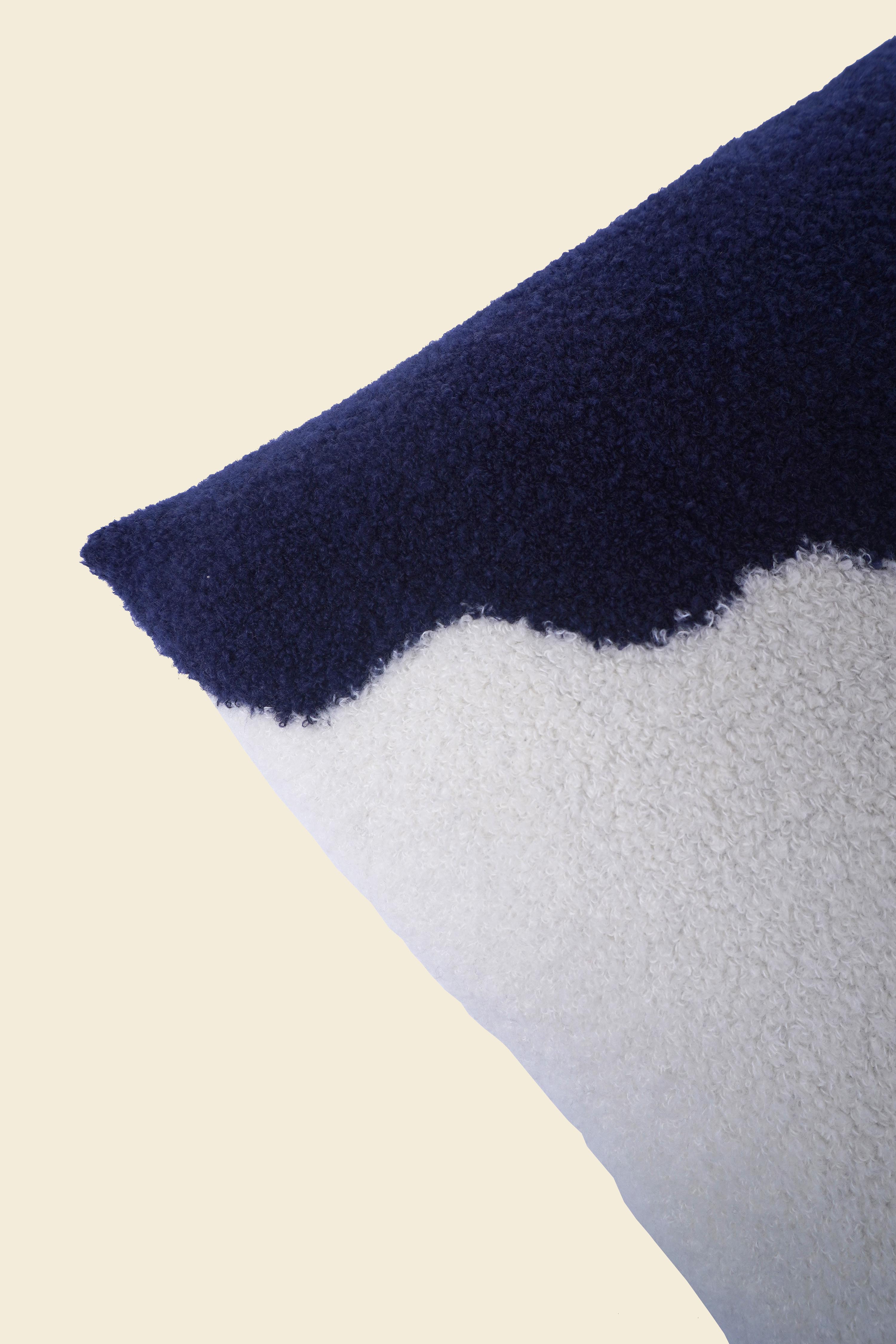 close-up of off-white/navy knit plush pillowcase in viscose and merino wool