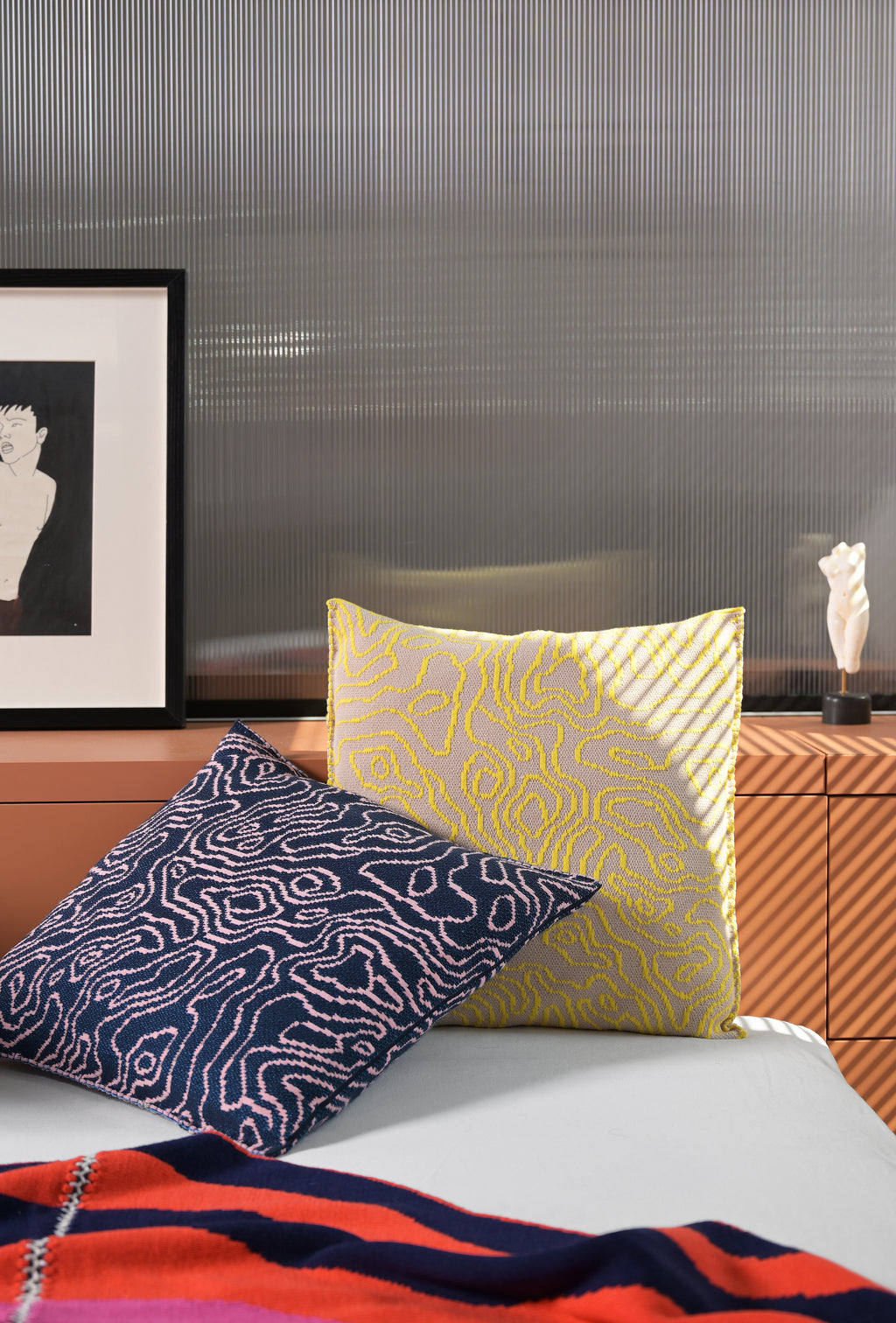 navy/pink soft viscose knit pillowcase with organic curves pattern on bed