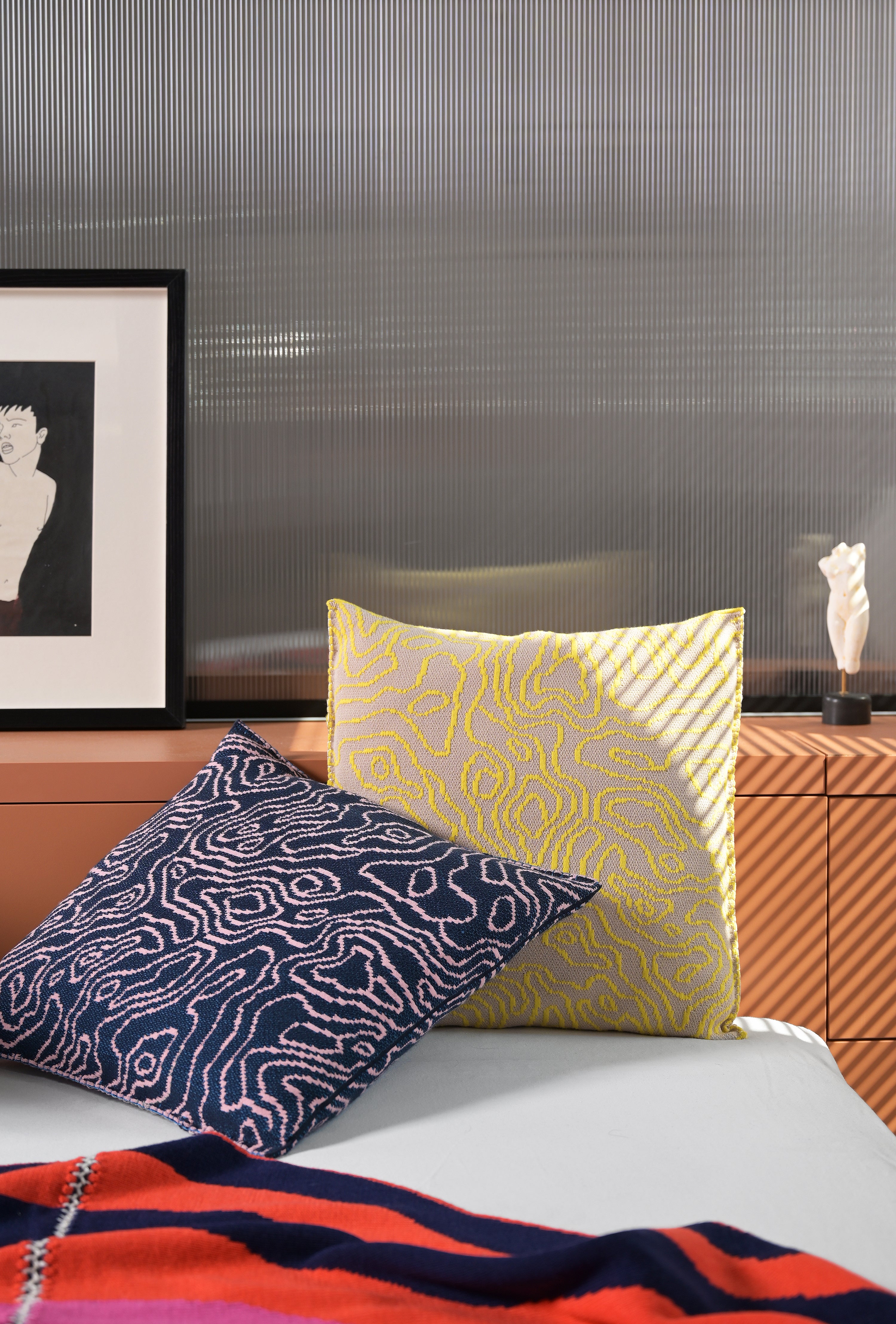 navy/pink soft viscose knit pillowcase with organic curves pattern on bed