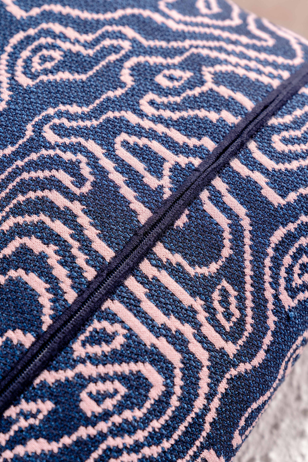 detail of navy/pink soft viscose knit pillowcase with organic curves pattern