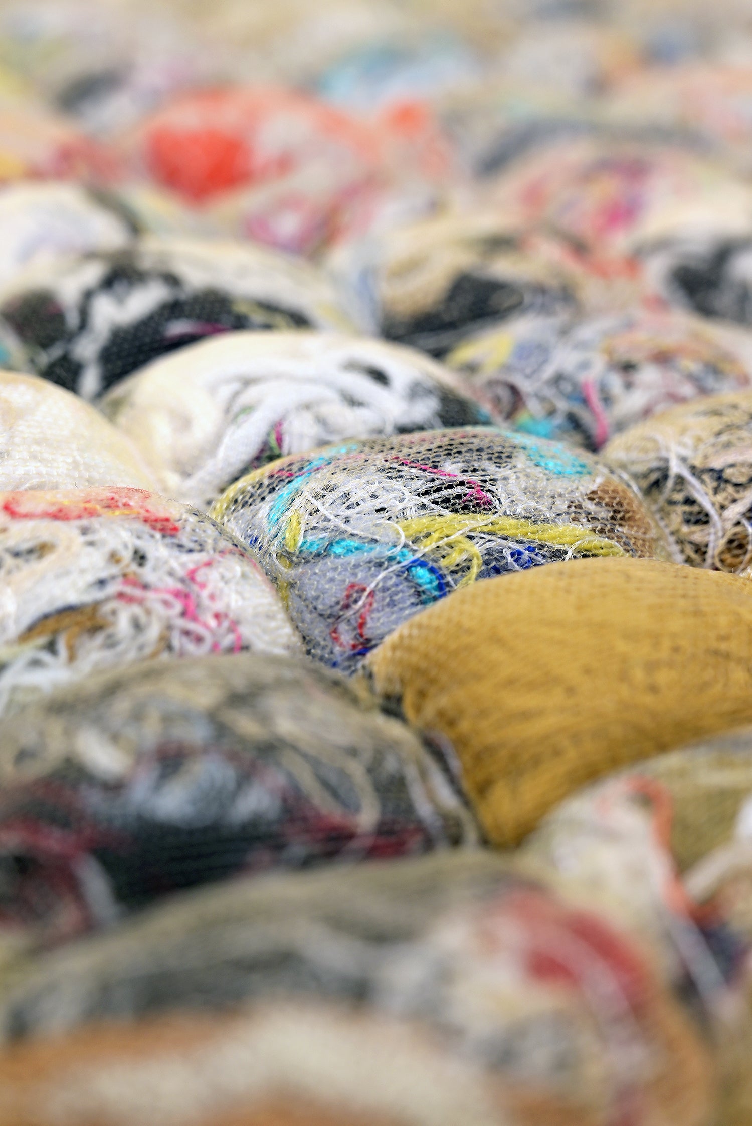 close-up of knit seat cushion with transparent cover filled with upcycled materials