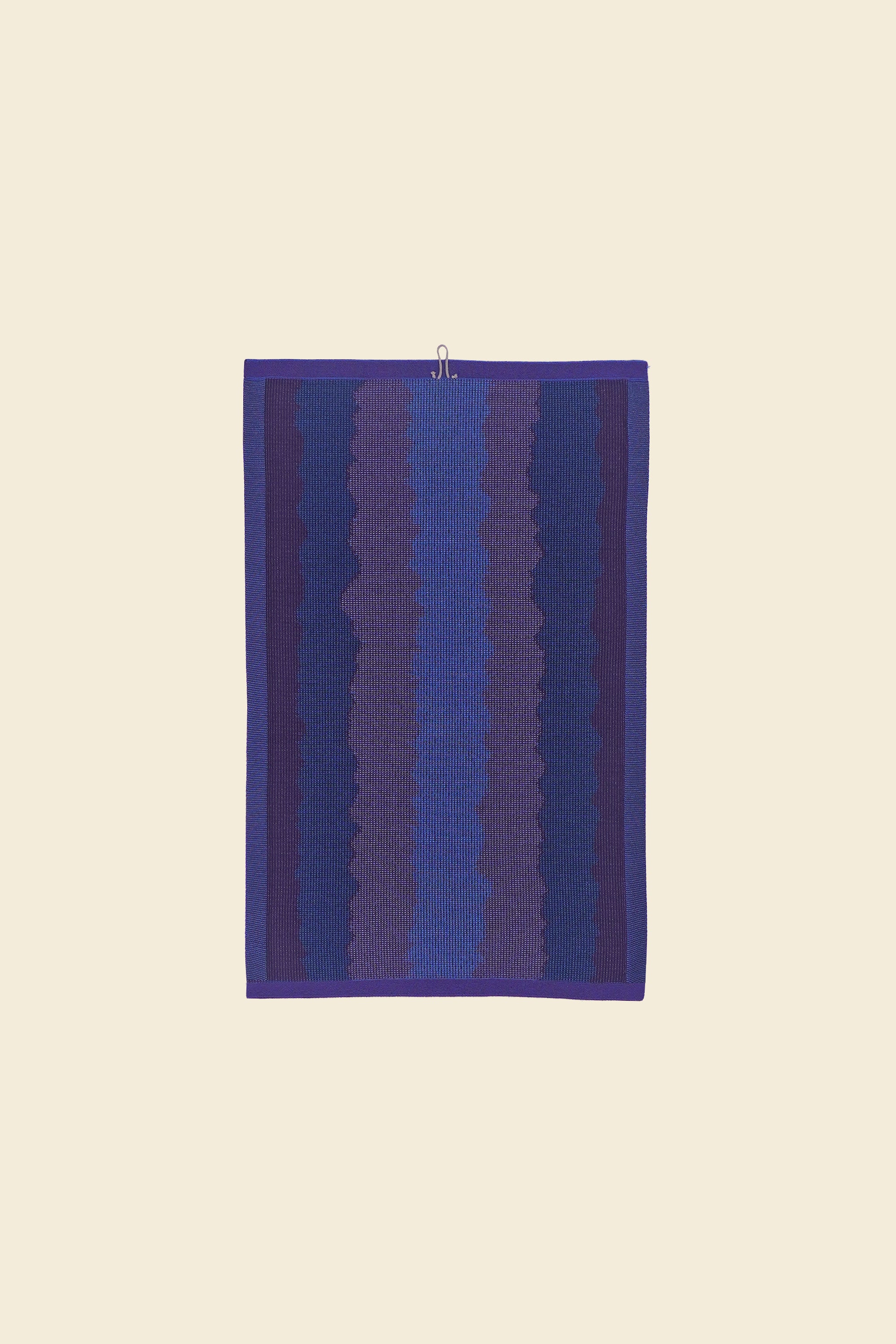back view of purple knit organic cotton kitchen towel with wavy pattern