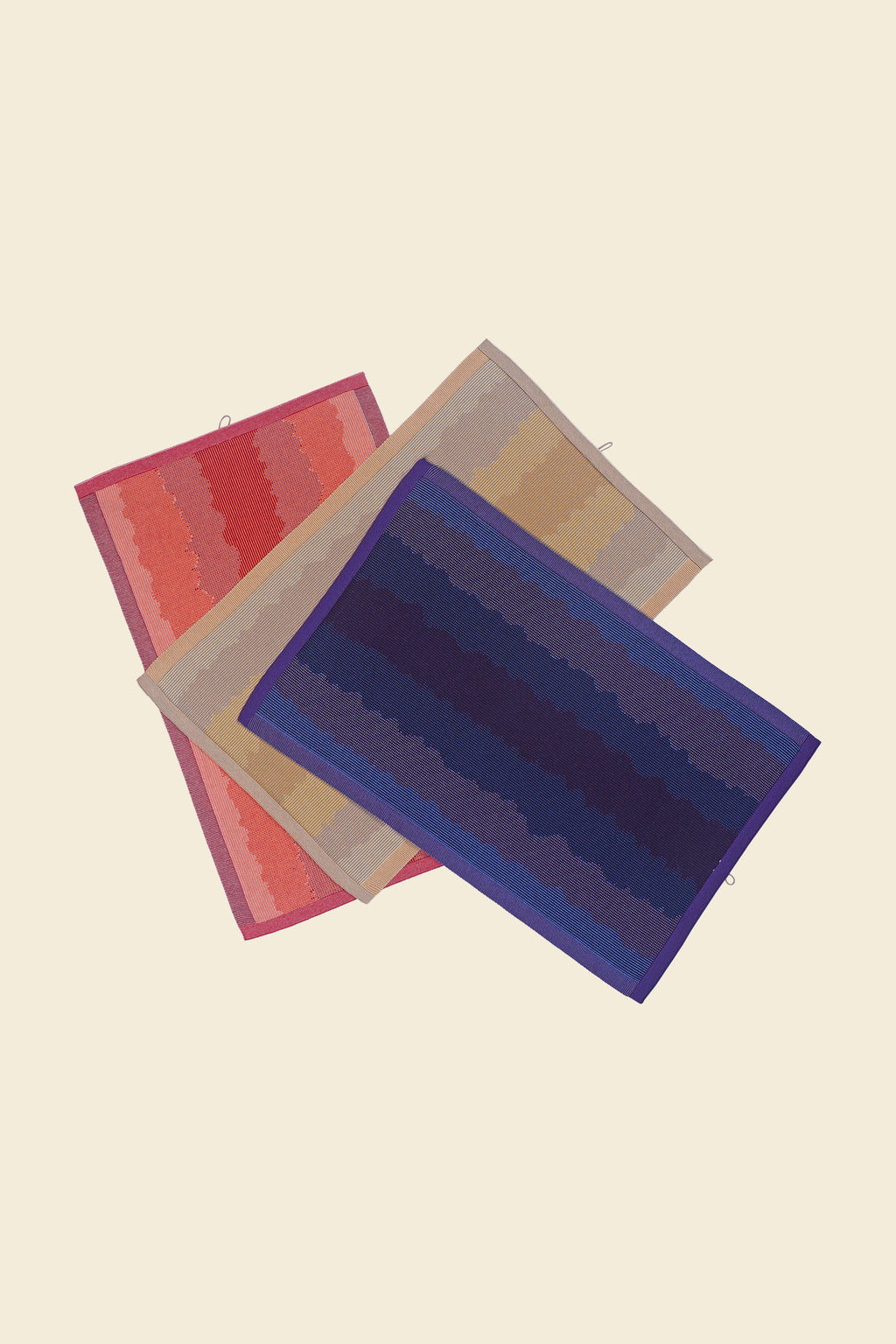 front view of purple, red and yellow knit organic cotton kitchen towel set with wavy pattern stacked