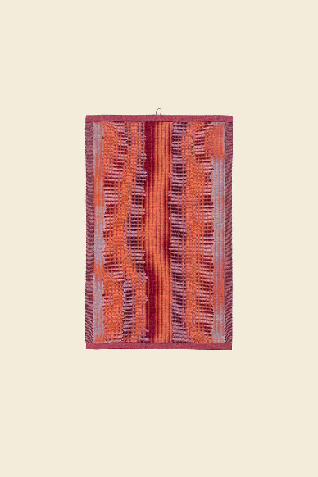 front view of red knit organic cotton kitchen towel with wavy pattern