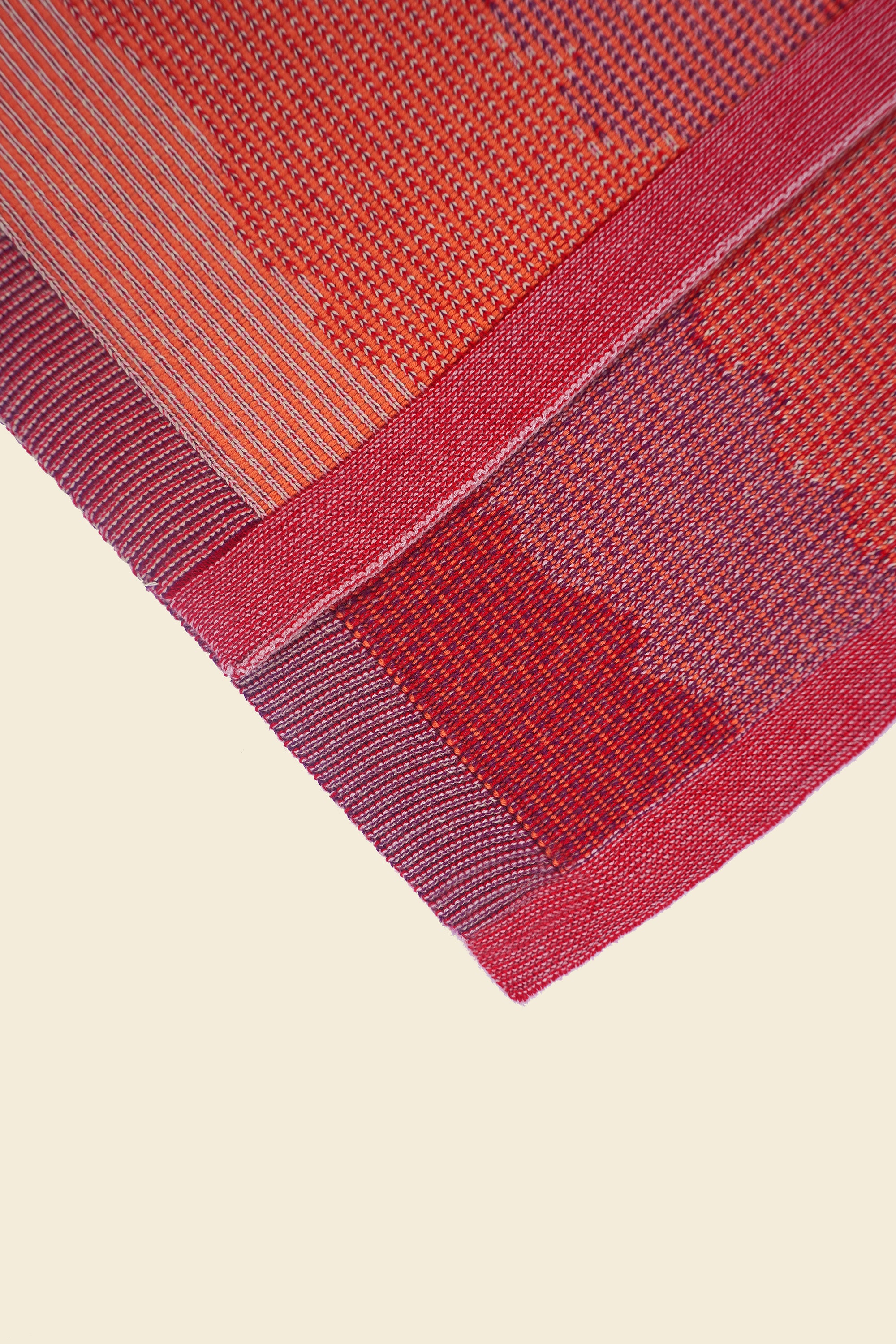 corner of red knit organic cotton kitchen towel set with wavy pattern