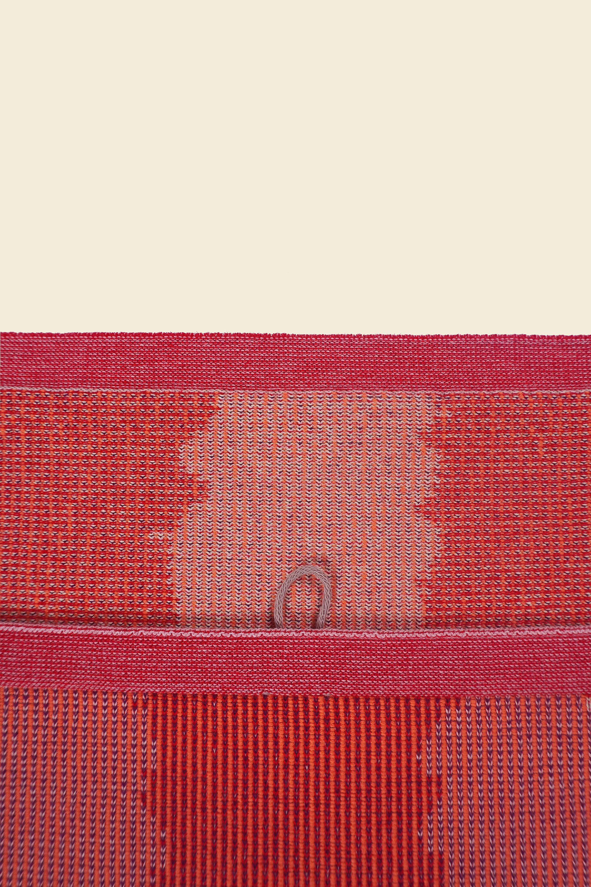 top detail of red knit organic cotton kitchen towel with wavy pattern